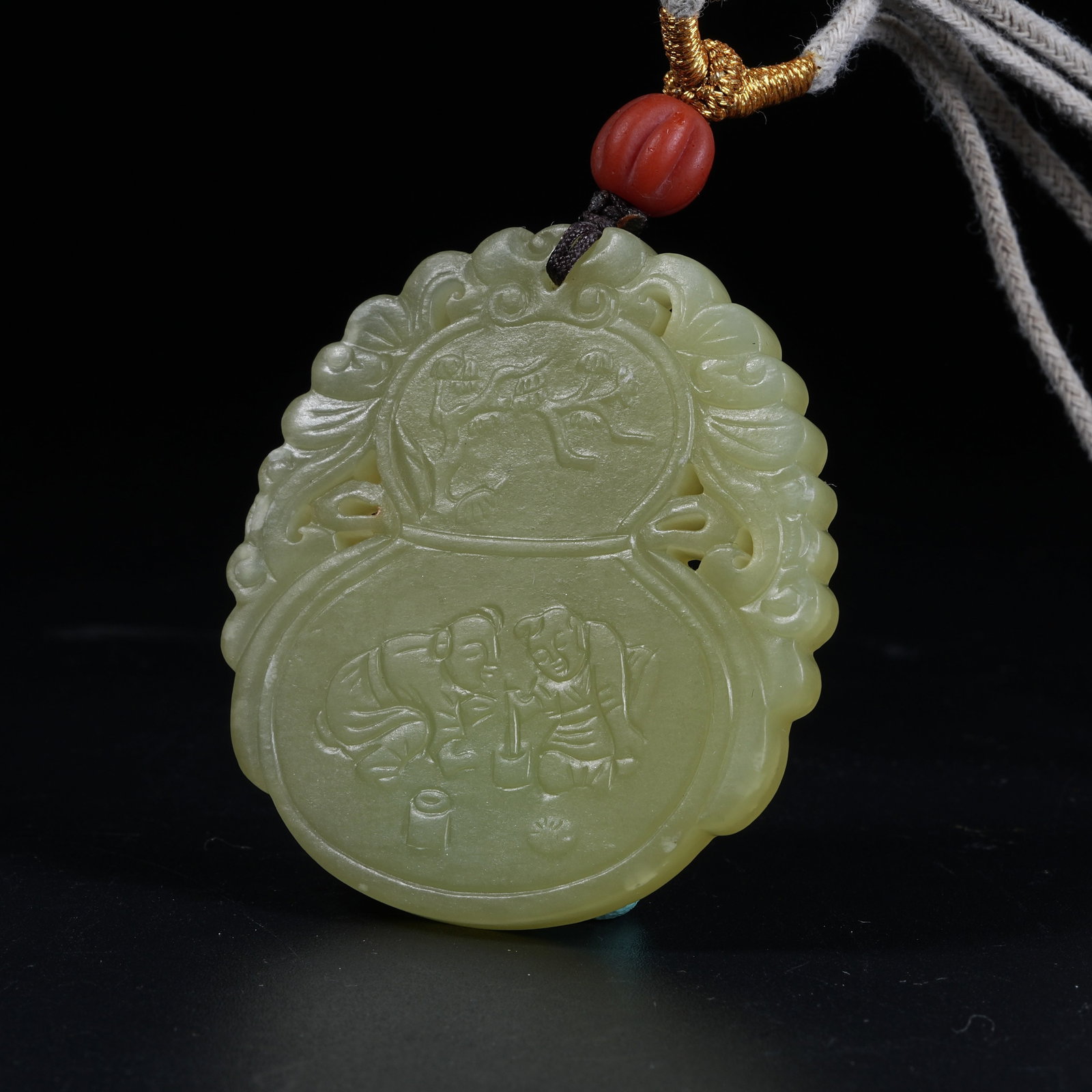 A HETIAN TOPAZ PENDANT WITH ANTIQUE MOTIFS SYMBOLIZING ETERNAL FORTUNE AND LONGEVITY: Hetian Topaz Pendant with Antique Motifs Symbolizing Eternal Fortune and Longevity