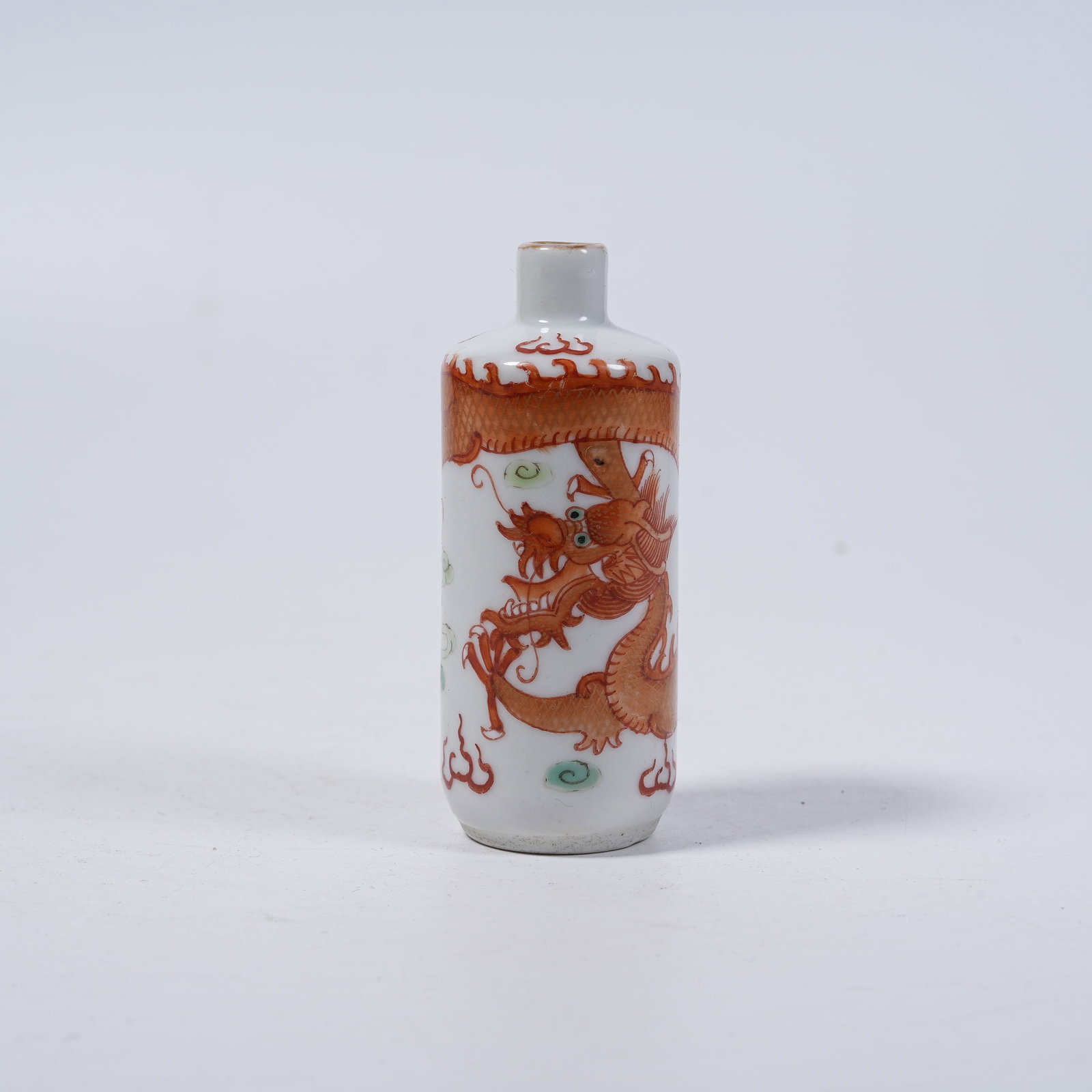 A IRON RED GILDED SNUFF BOTTLE WITH DRAGONS CHASING PEARLS PATTERN: Iron Red Gilded Snuff Bottle with Dragons Chasing Pearls Pattern