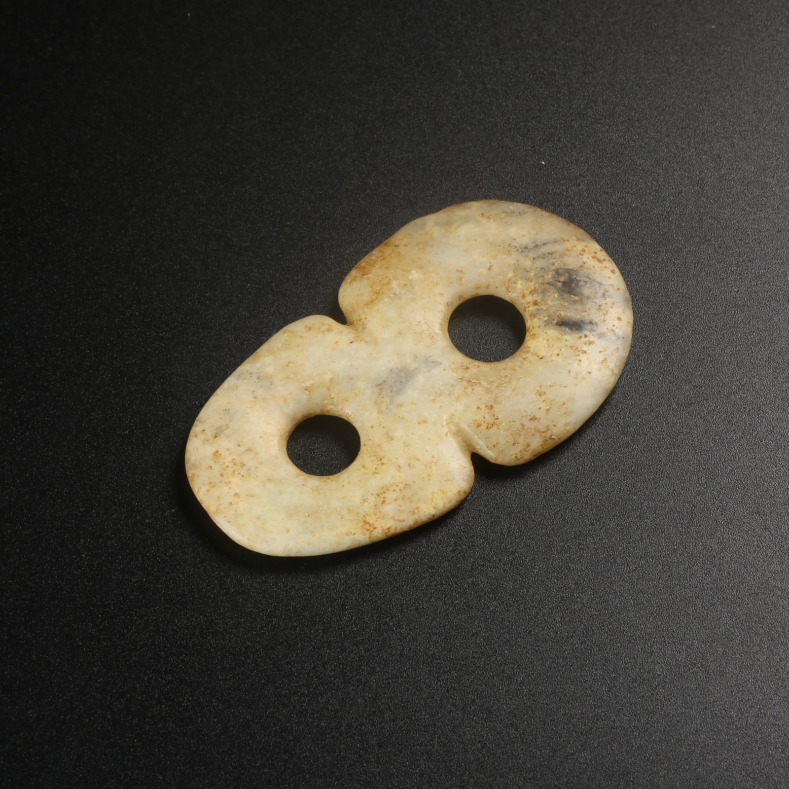 A ARCHAIC JADE FIGURE-EIGHT RING: Archaic jade figure-eight ring