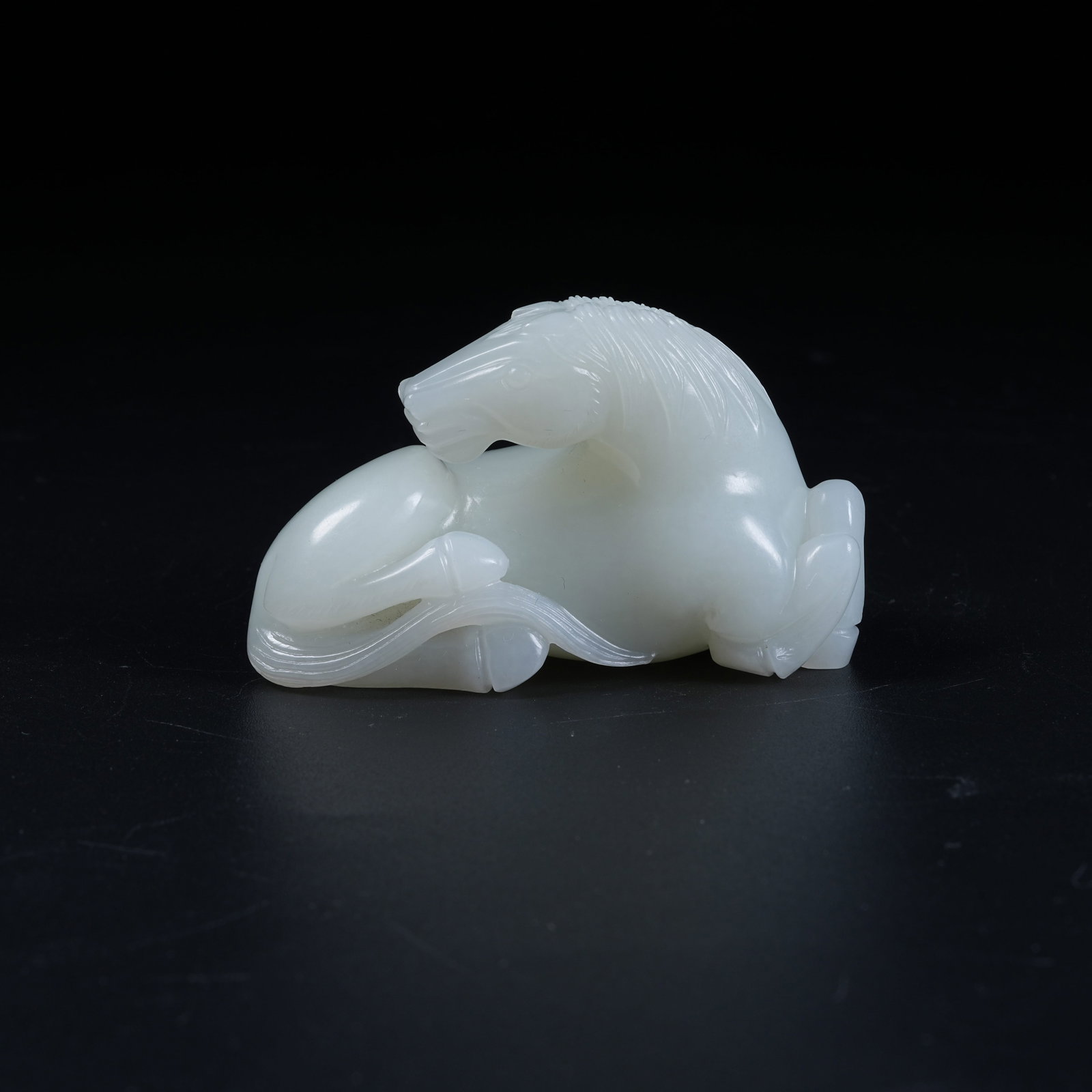 A RECUMBENT HORSE ORNAMENT OF HETIAN JADE: Recumbent Horse Ornament of Hetian Jade