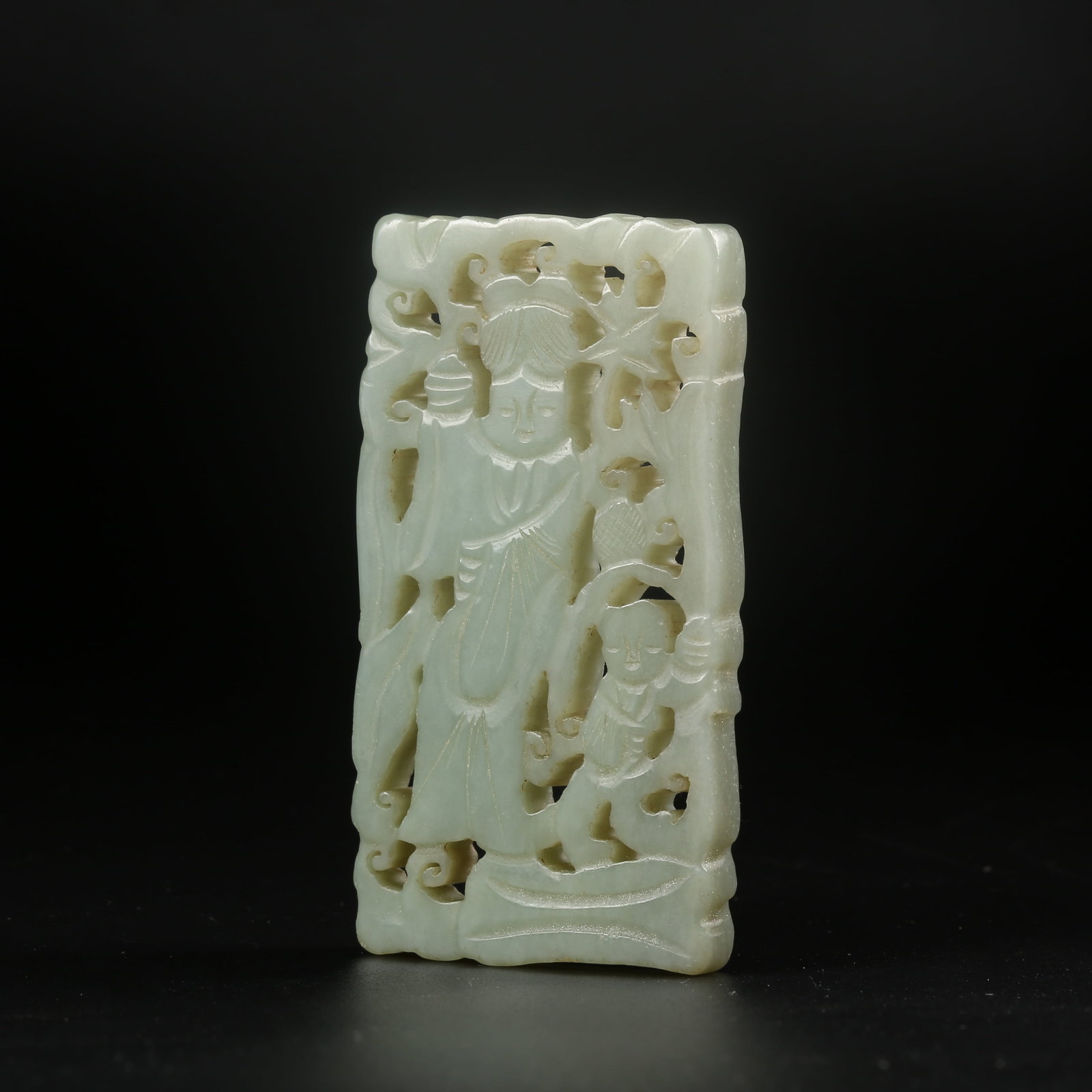 A HETIAN JADE PENDANT CARVED WITH A CHILD FIGURE: Hetian jade pendant carved with a child figure
