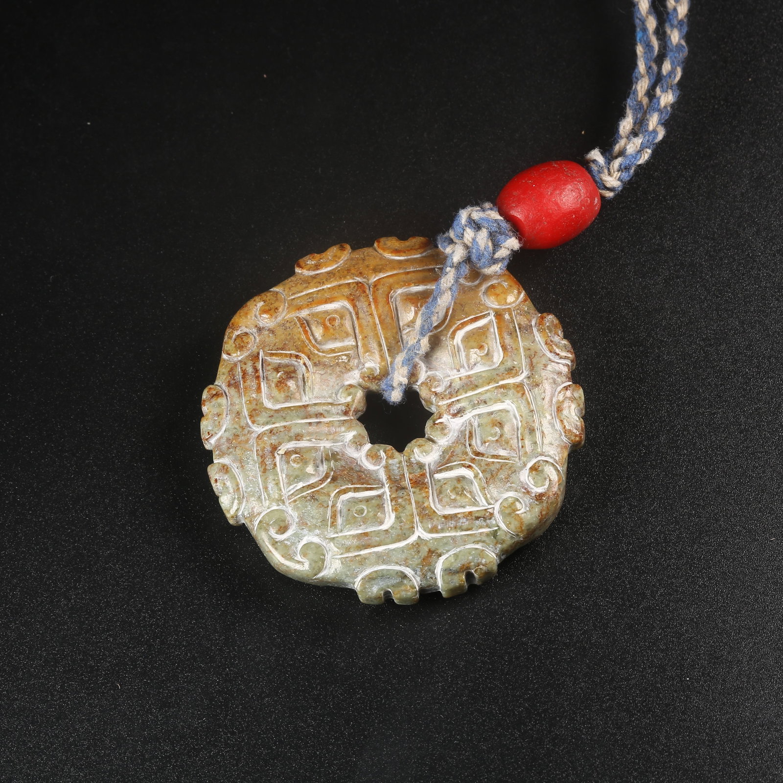 A ARCHAIC JADE BI-RING CARVED WITH BEAST-MASK MOTIFS: Archaic jade bi-ring carved with beast-mask motifs