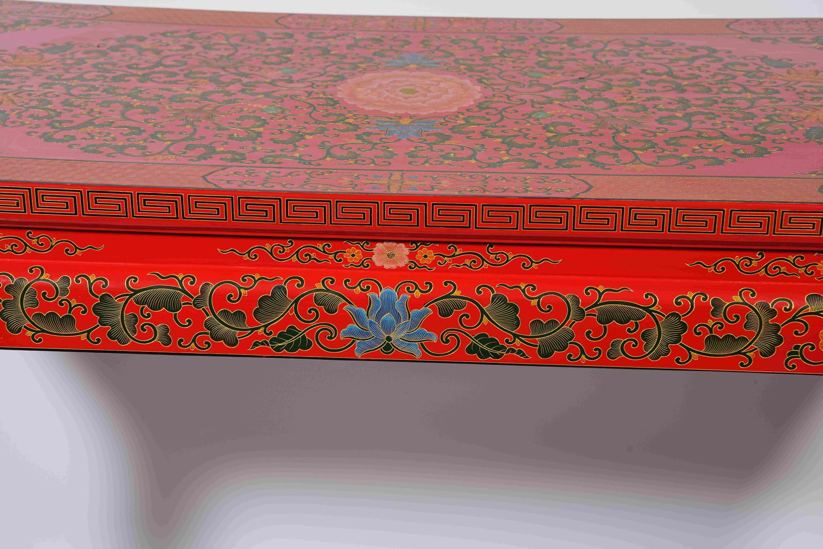 A RED CARVED LACQUER SIDE TABLE WITH INTERLOCKING FLORAL PATTERNS - 13