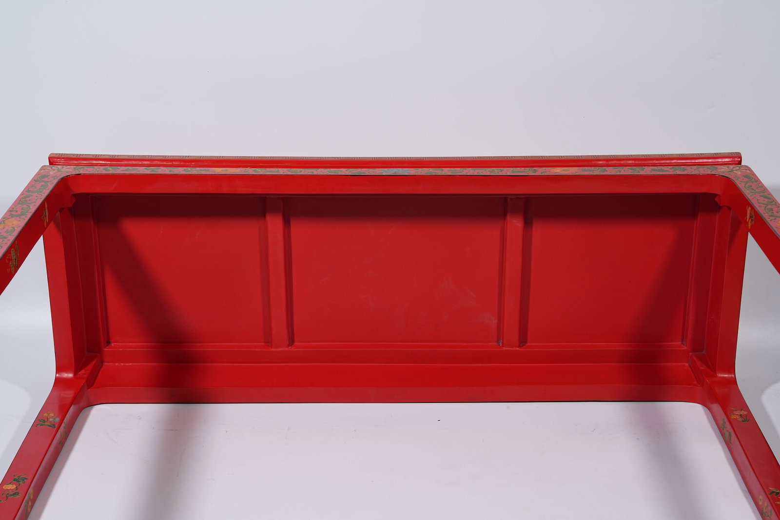 A RED CARVED LACQUER SIDE TABLE WITH INTERLOCKING FLORAL PATTERNS - 14