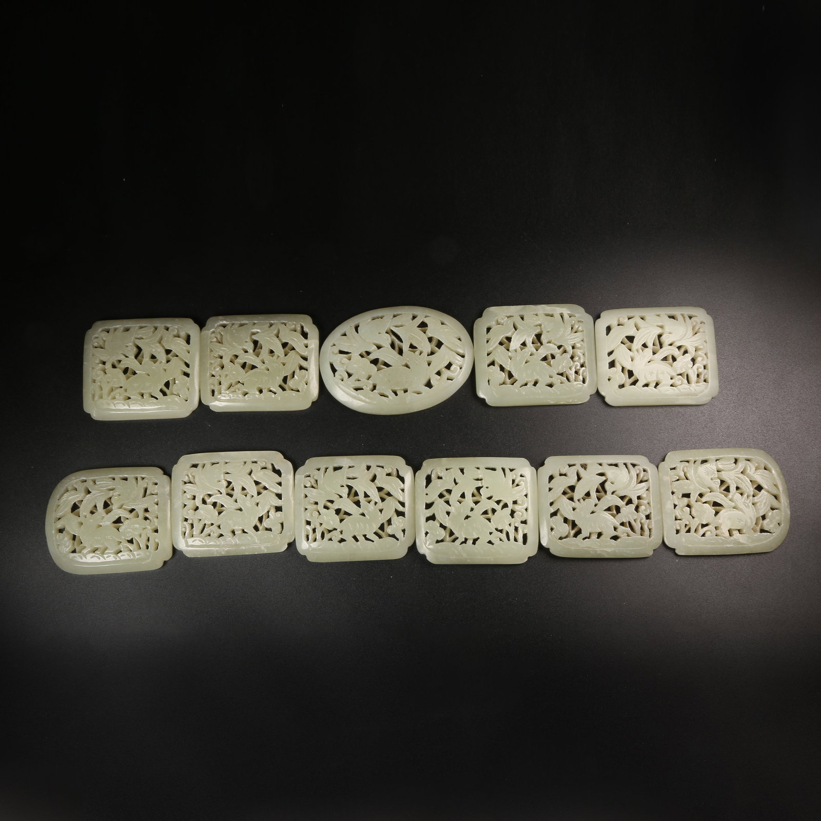 A GROUP OF HETIAN JADE BELT PLAQUES CARVED WITH AUSPICIOUS BEAST MOTIFS: Group of Hetian jade belt plaques carved with auspicious beast motifs