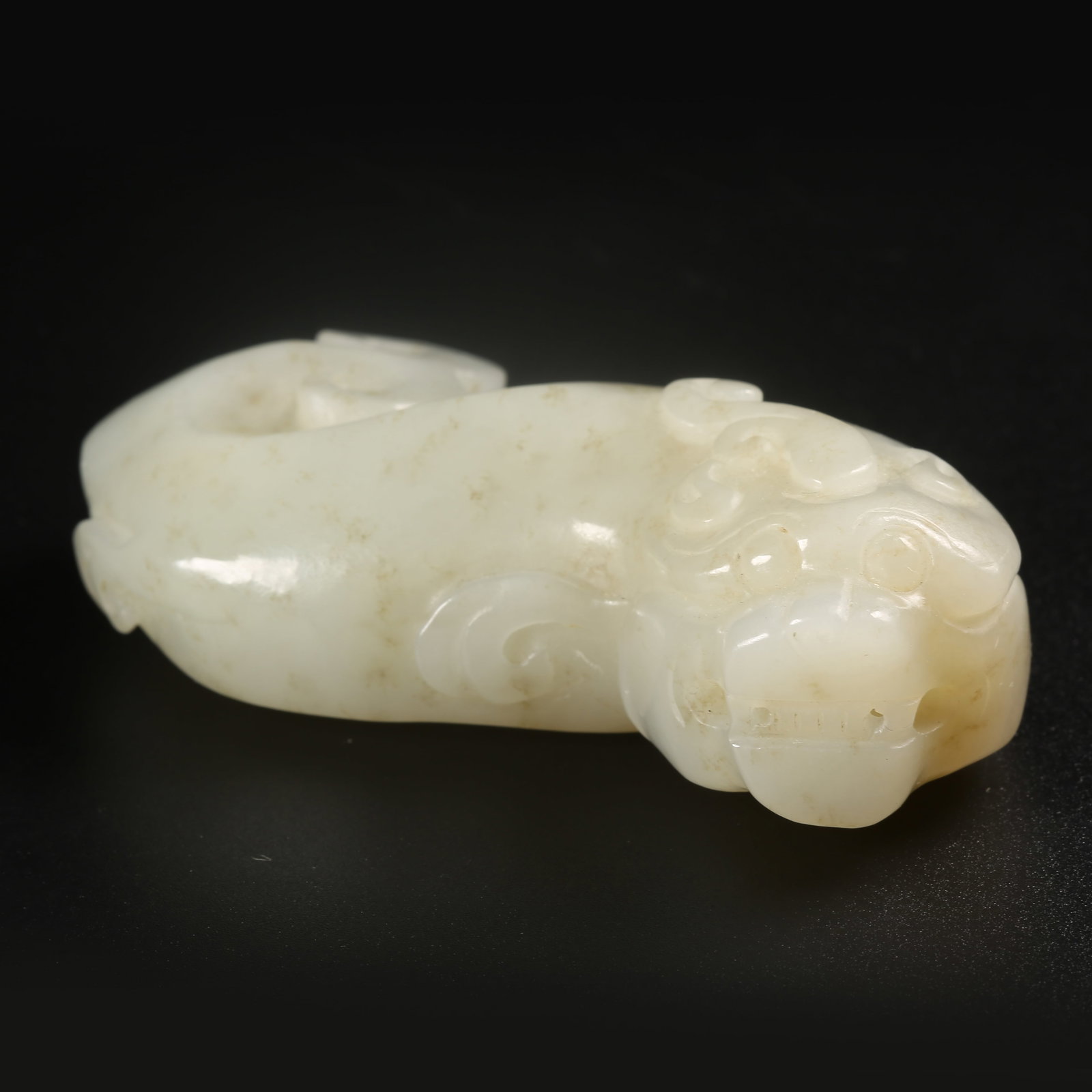 A HETIAN JADE HANDHELD CARVING WITH AUSPICIOUS BEAST MOTIFS (1 of 8)