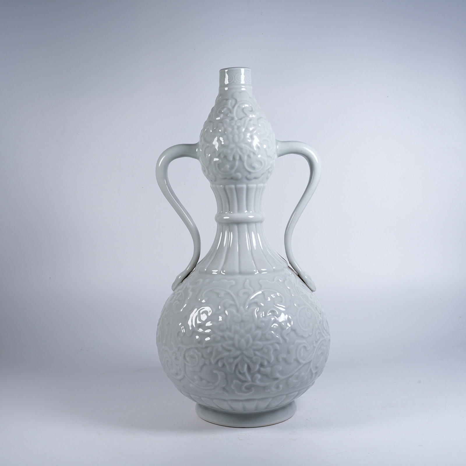 A WHITE GLAZE GOURD VASE WITH RIBBON EARS AND SUBTLY INCISED FLORAL PATTERN (1 of 10)