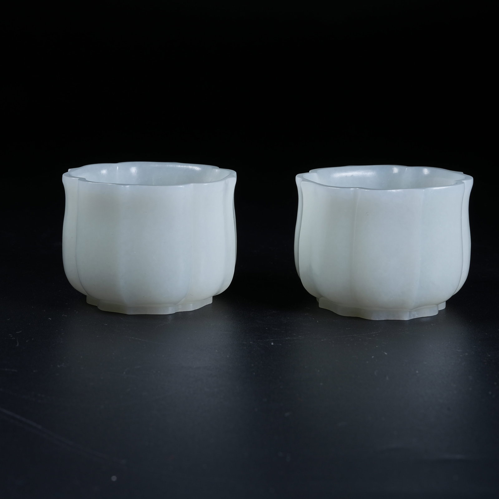 A SET OF FLOWER-RIMMED CUPS OF HETIAN WHITE JADE (1 of 10)