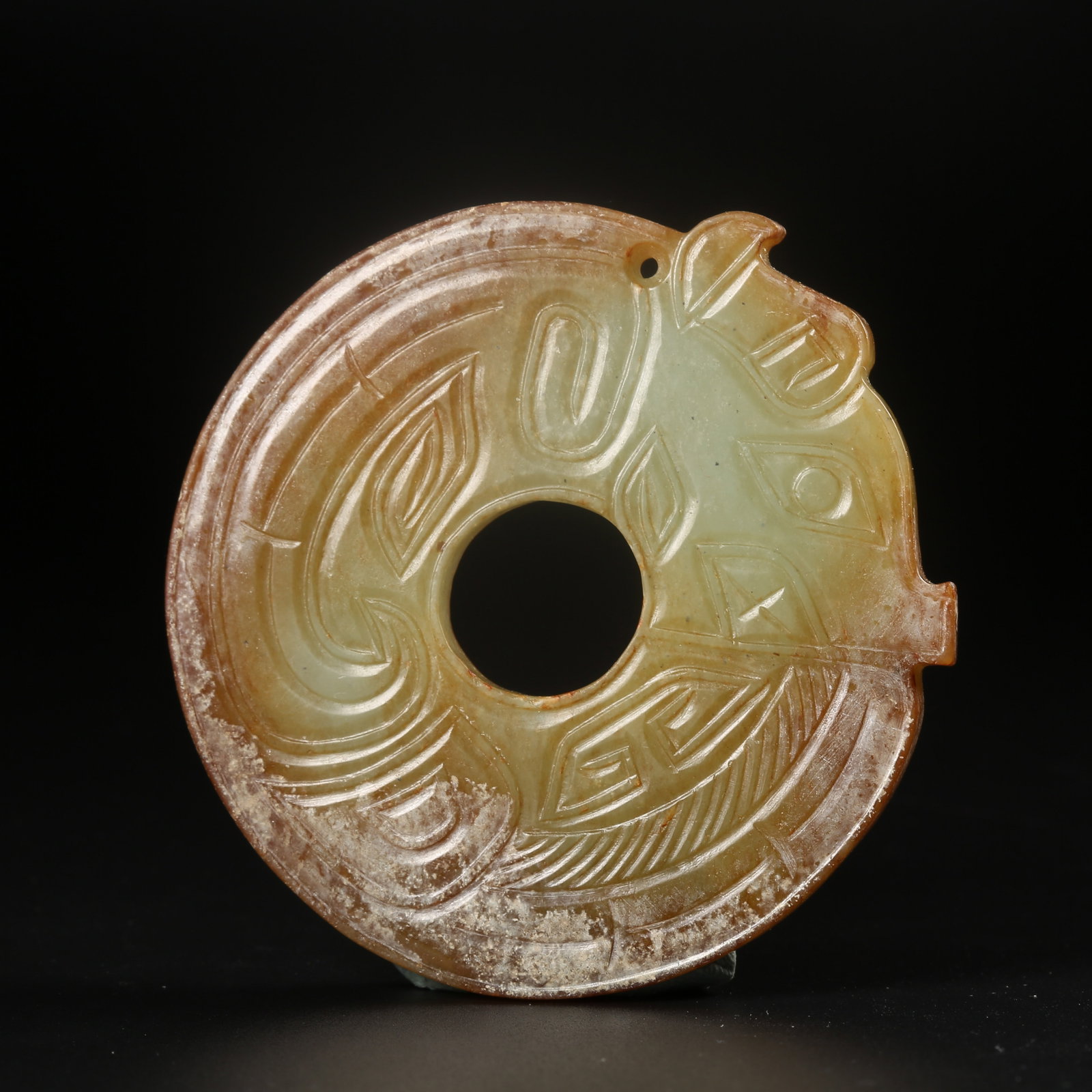 A ARCHAIC JADE RING CARVED WITH AUSPICIOUS BEAST MOTIFS: Archaic jade ring carved with auspicious beast motifs