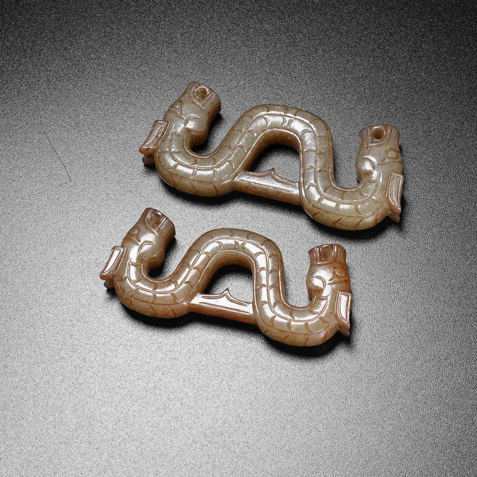 A GROUP OF S-SHAPED DRAGON PENDANTS OF ANCIENT JADE: Group of S-Shaped Dragon Pendants of Ancient Jade