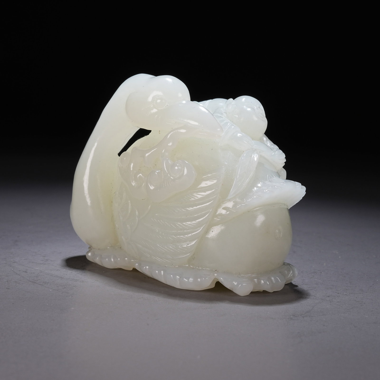 A HETIAN WHITE JADE "AUSPICIOUS DUCK PRESENTING GOOD FORTUNE" ORNAMENT: Hetian White Jade "Auspicious Duck Presenting Good Fortune" Ornament