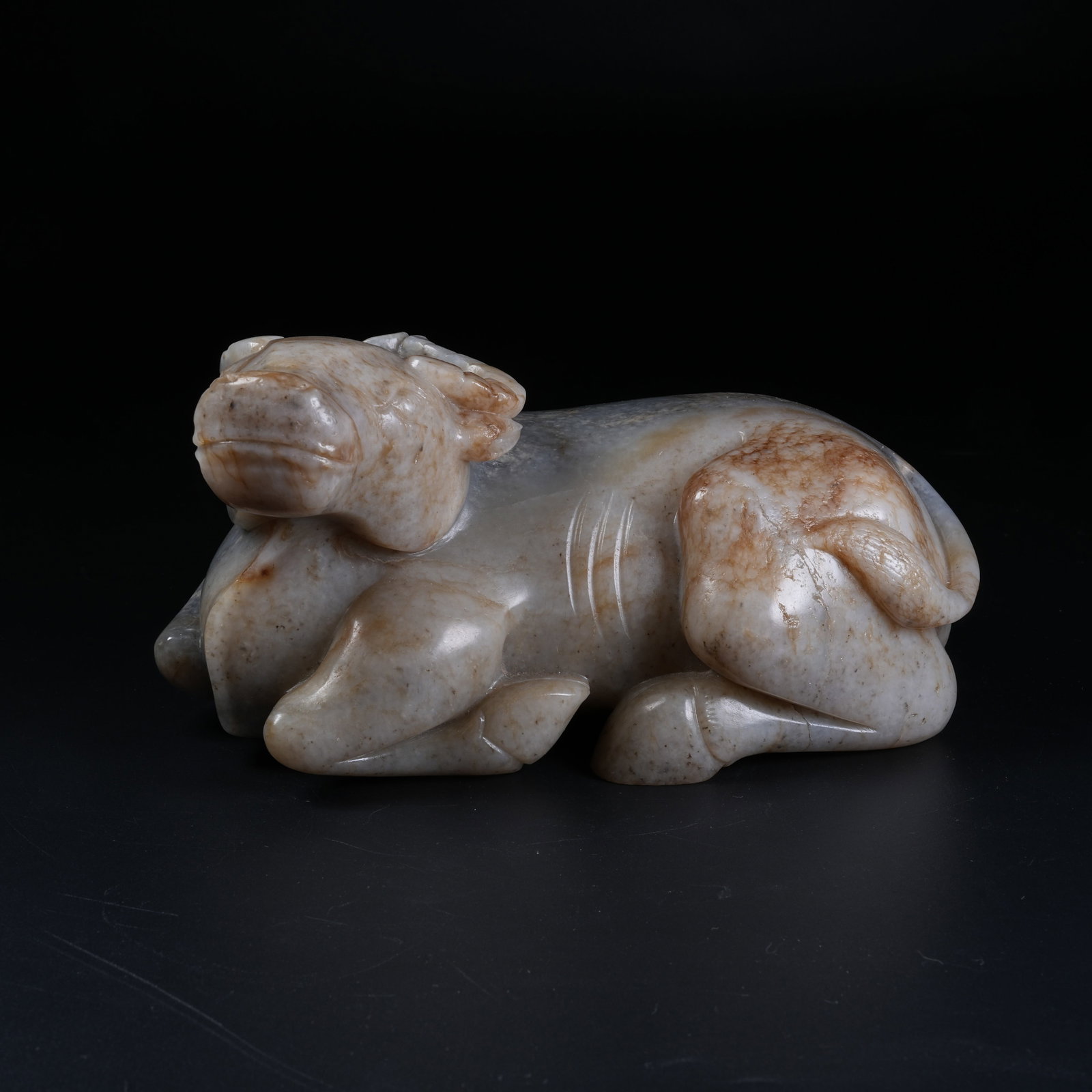 A RECUMBENT OX ORNAMENT OF HETIAN JADE (1 of 8)