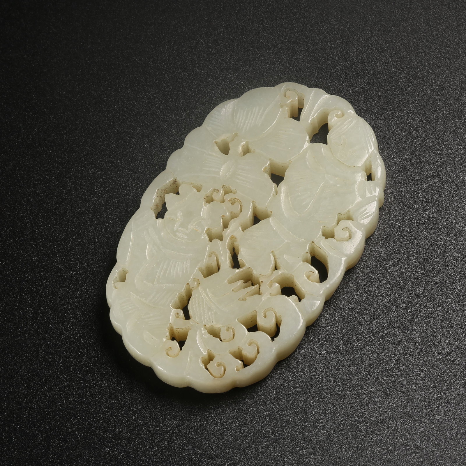 A HETIAN JADE PLAQUE CARVED WITH A CHILD FIGURE: Hetian jade plaque carved with a child figure