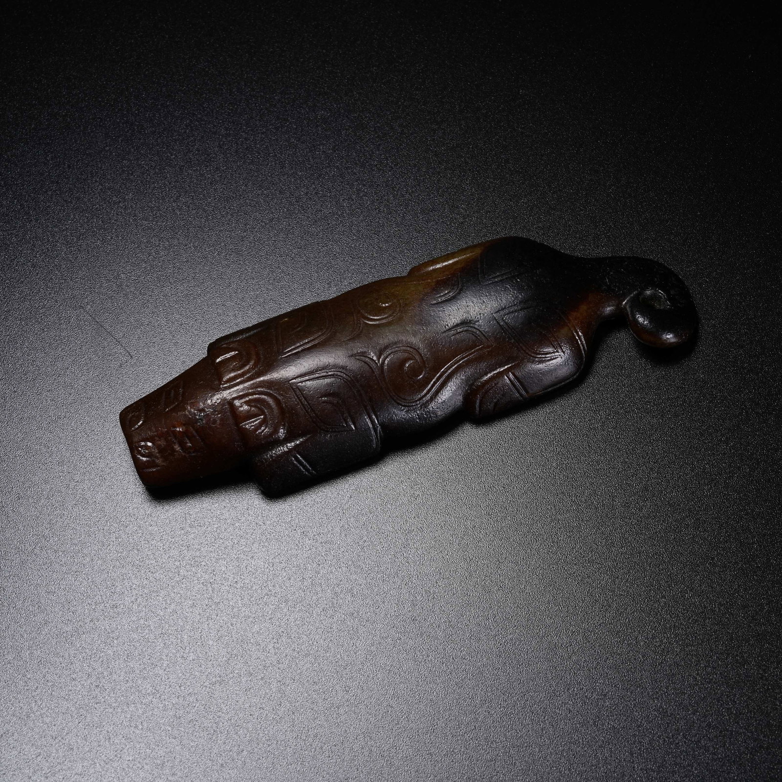 A ANCIENT JADE RECUMBENT BEAST PENDANT: Ancient Jade Recumbent Beast Pendant