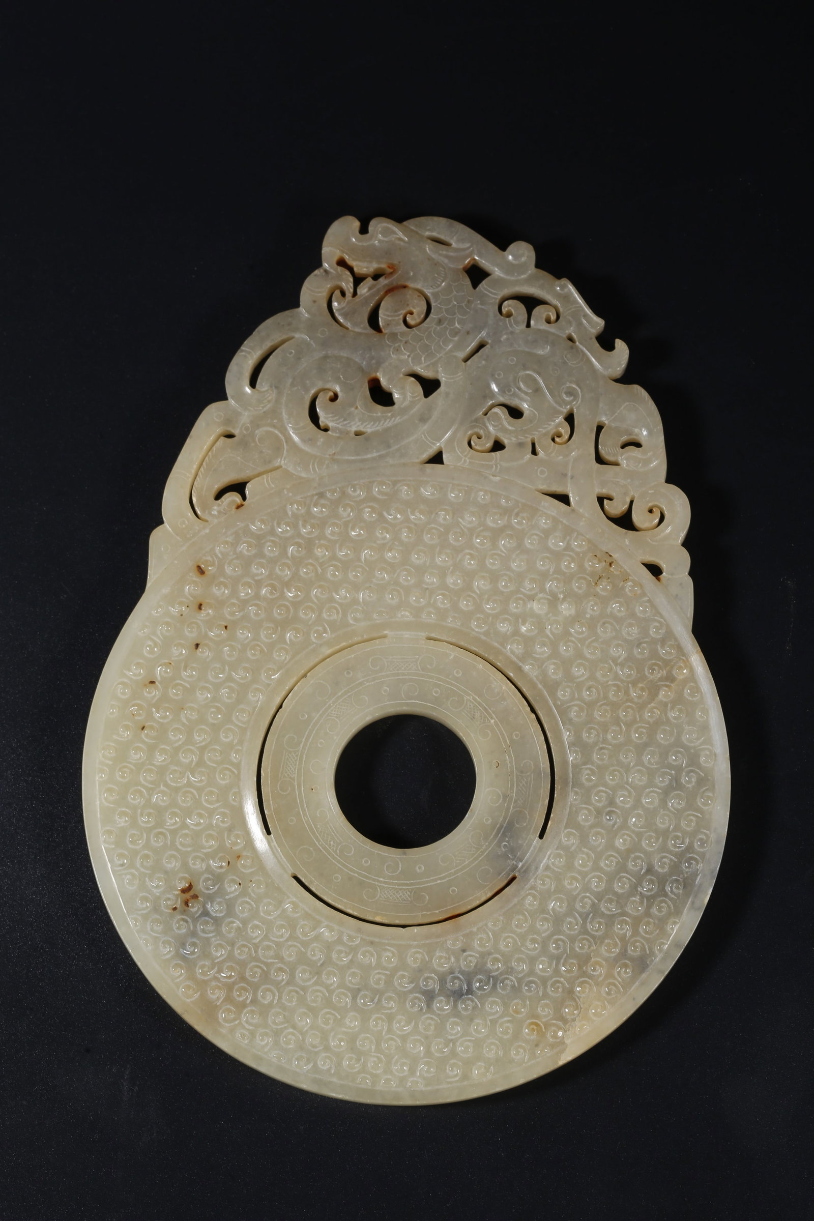 A ARCHAIC JADE BI DISC WITH OUTER DRAGON CARVINGS (1 of 9)