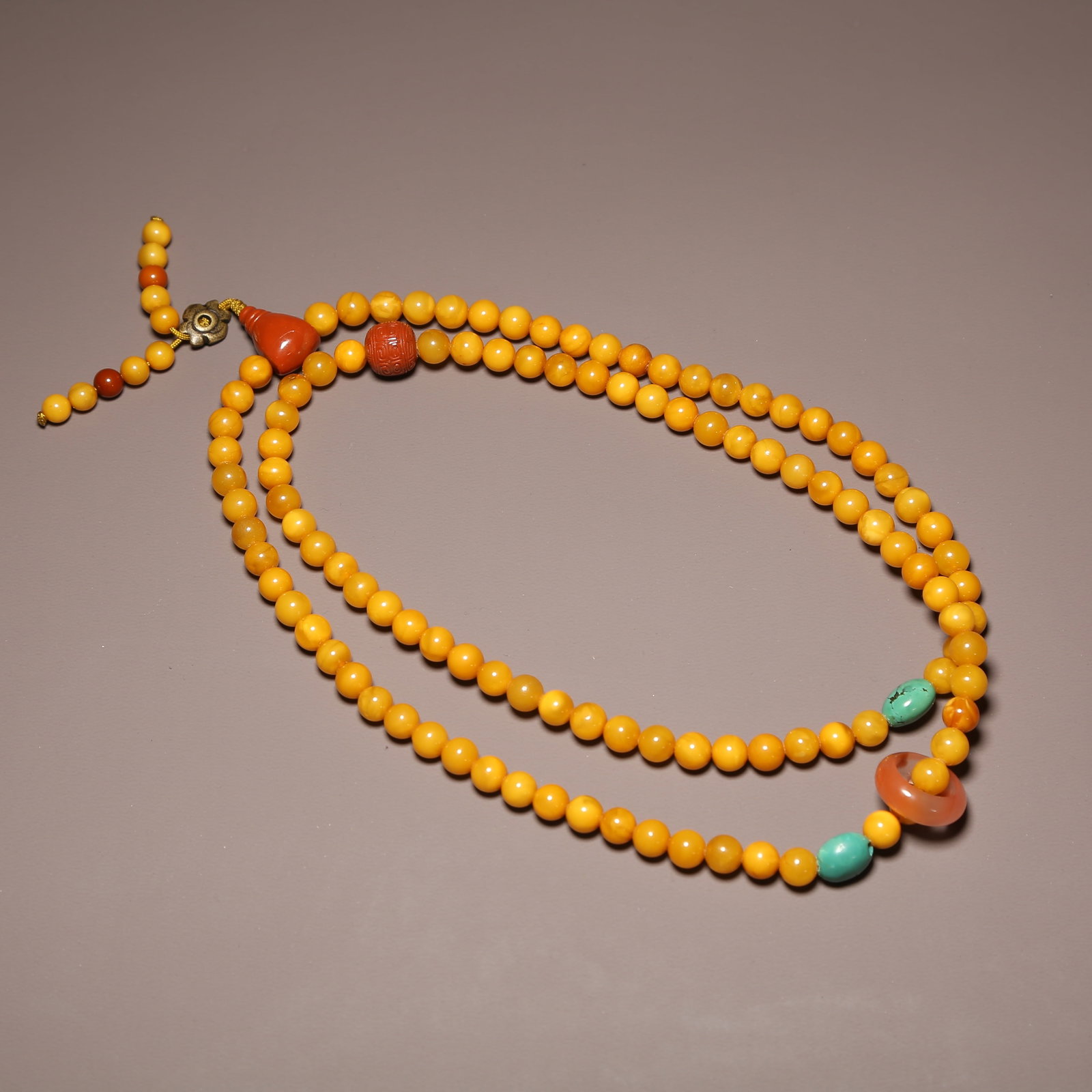 A STRAND OF BEESWAX PRAYER BEADS (1 of 9)