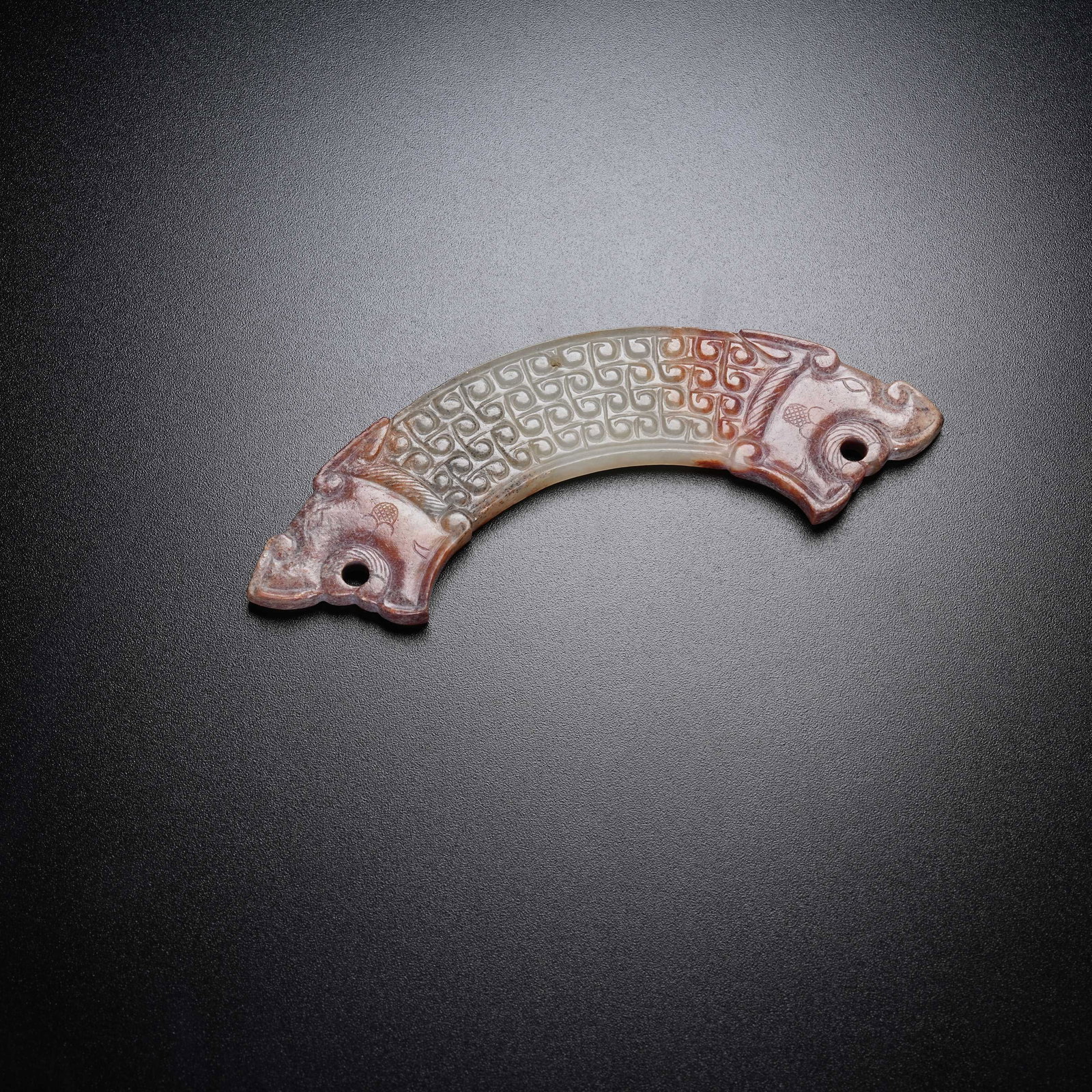 A ANCIENT JADE HUANG ARC PENDANT WITH BEAST HEADS: Ancient Jade Huang Arc Pendant with Beast Heads