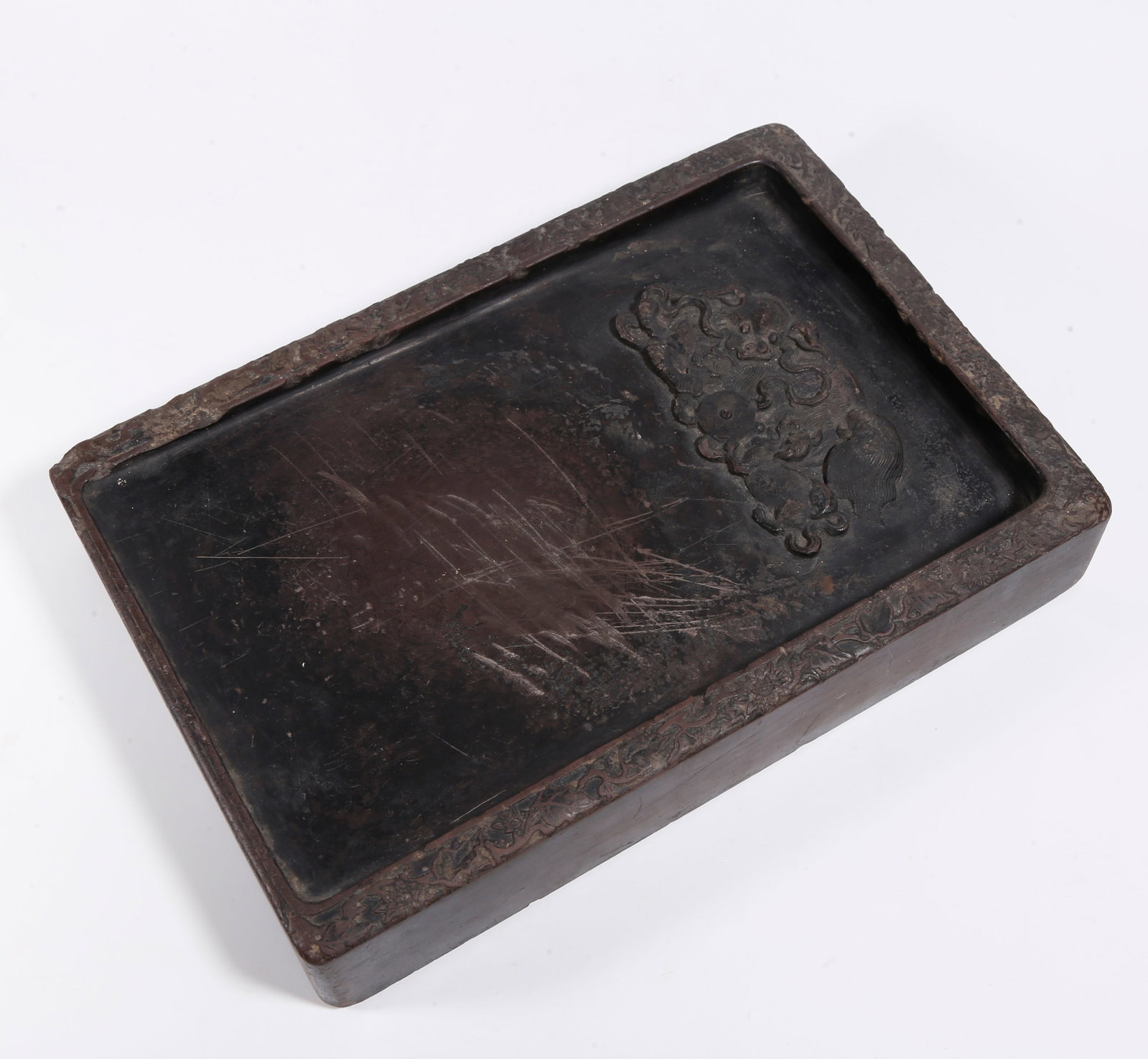 A DUAN INKSTONE CARVED WITH BIG AND SMALL LIONS: Duan Inkstone Carved with Big and Small Lions