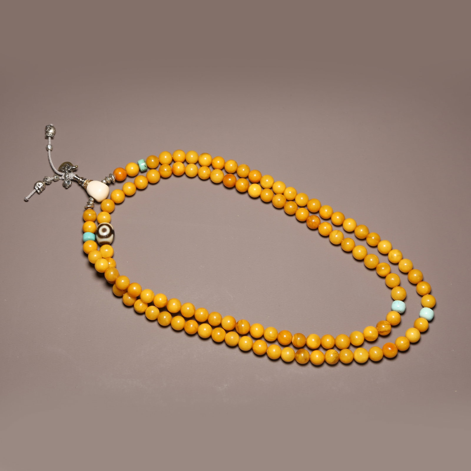 A STRAND OF BEESWAX PRAYER BEADS (1 of 9)