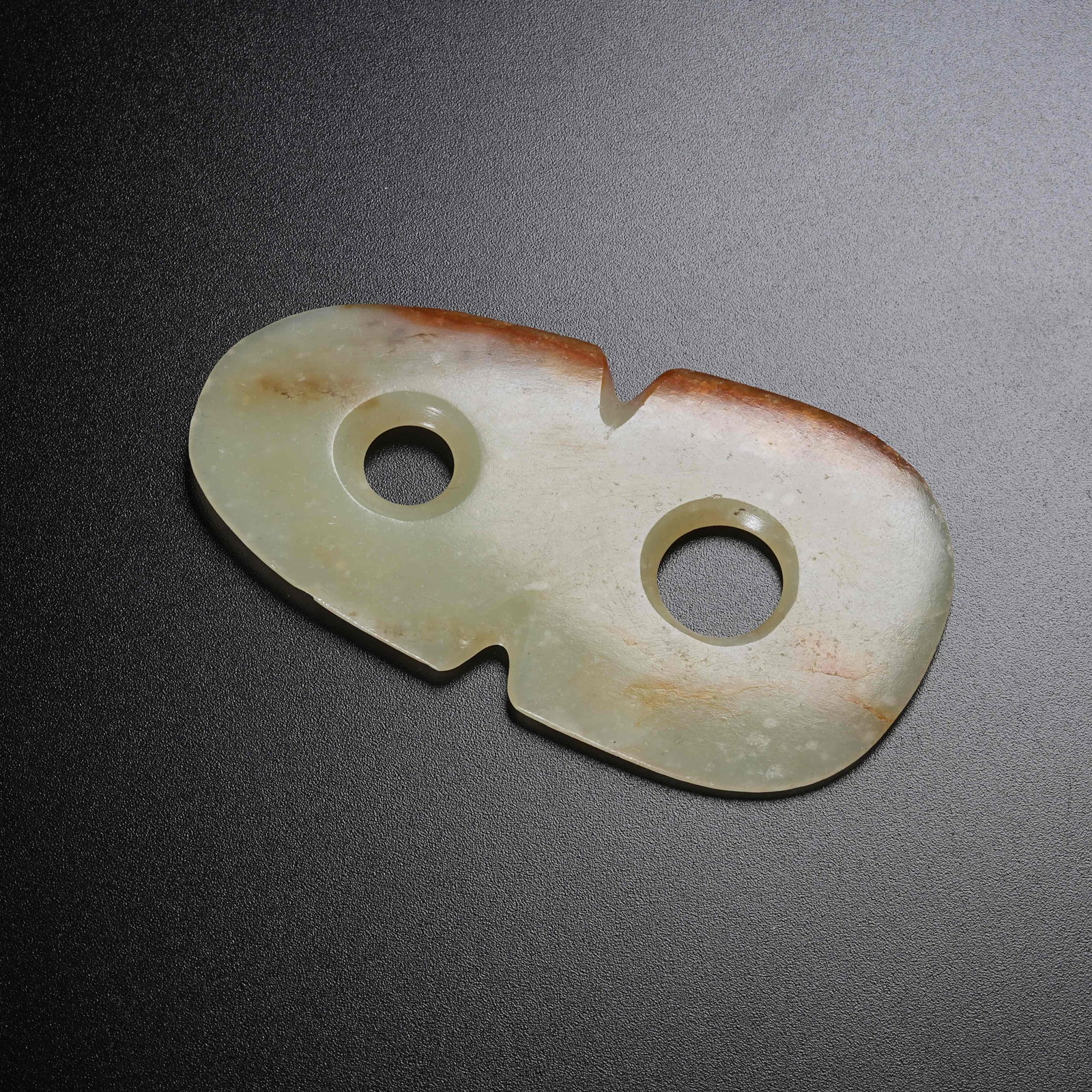 A ANCIENT JADE FIGURE-EIGHT RING: Ancient Jade Figure-Eight Ring