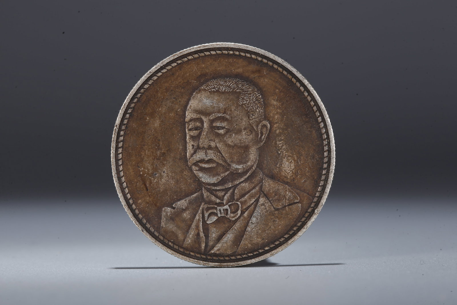 A SILVER DOLLAR COIN - 3