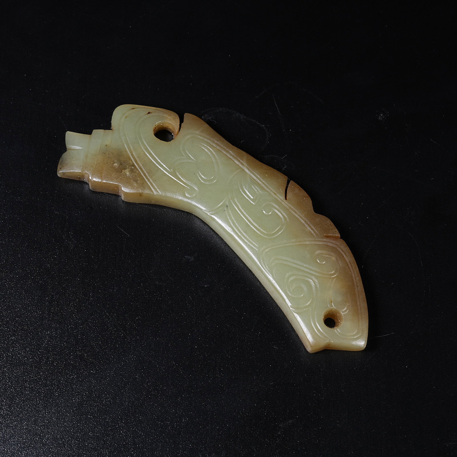 A ANCIENT JADE HUANG ARC PENDANT WITH BEAST HEAD TERMINALS: Ancient Jade Huang Arc Pendant with Beast Head Terminals
