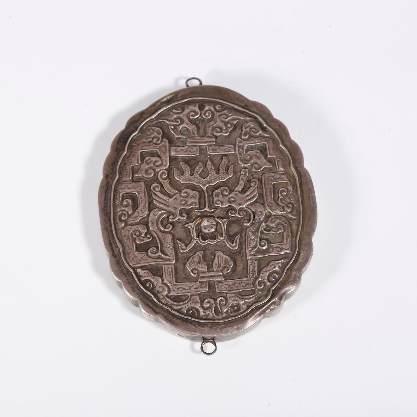 A SILVER PENDANT WITH DRAGON AND CLOUD PATTERNS: Silver Pendant with Dragon and Cloud Patterns