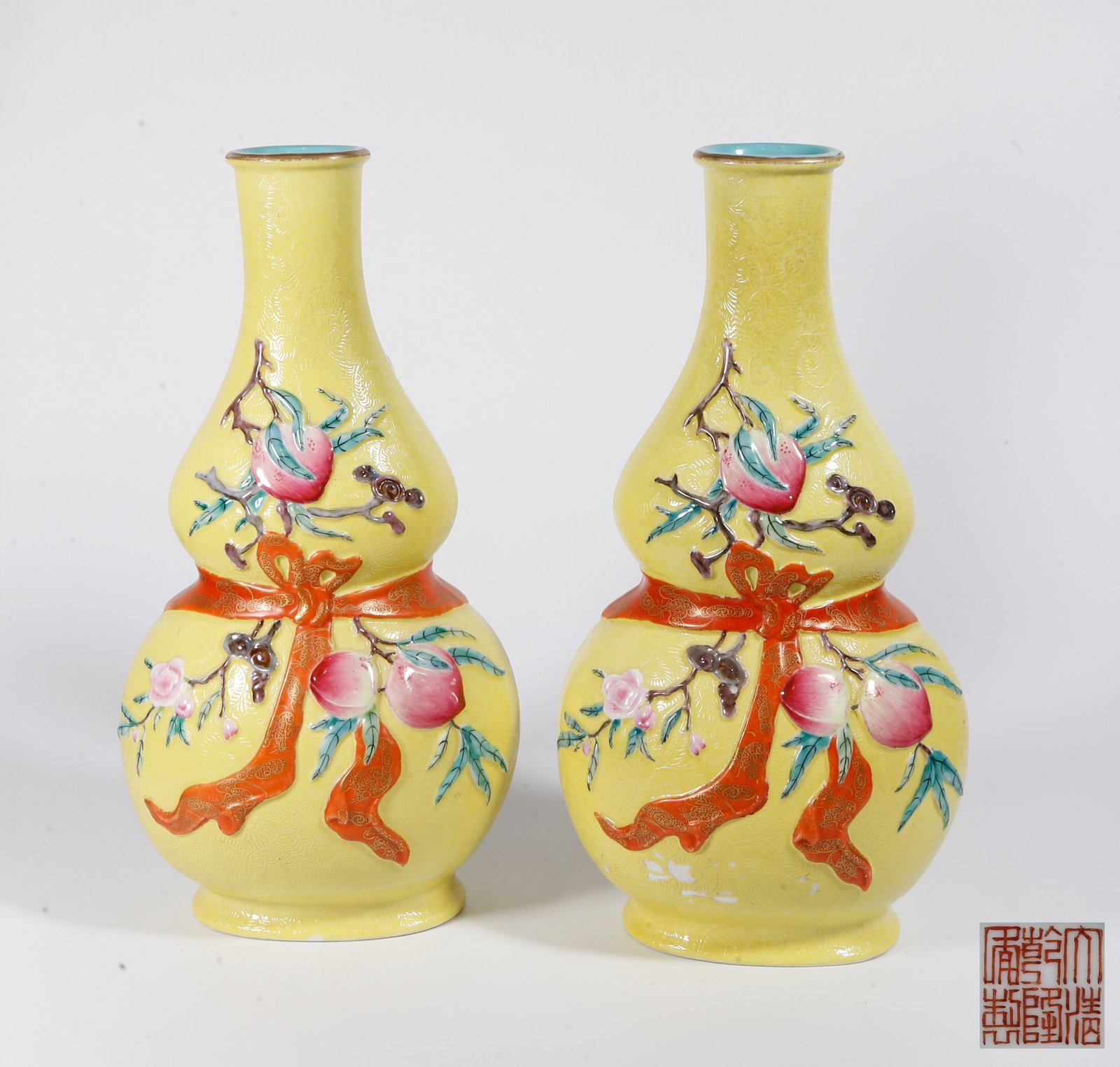 A GOURD VASE WITH CLOTH POUCH DESIGN, YELLOW GROUND FAMILLE ROSE WITH ROLLING PATTERN AND FORTUNE &: Gourd Vase with Cloth Pouch Design, Yellow Ground Famille Rose with Rolling Pattern and Fortune & Longevity Motifs (A Pair)