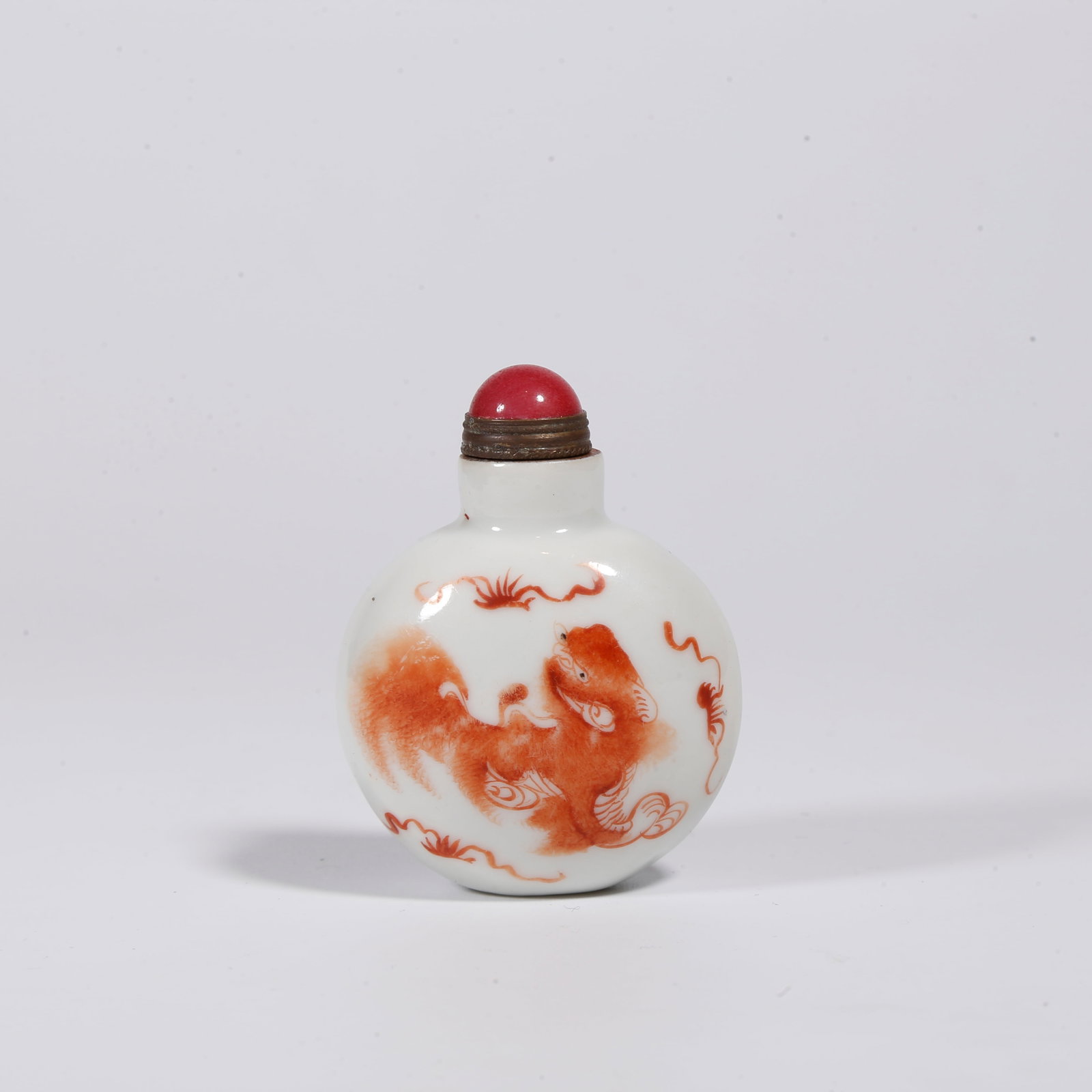 A IRON RED SNUFF BOTTLE WITH "EVERYTHING GOES WELL" MOTIFS: Iron Red Snuff Bottle with "Everything Goes Well" Motifs