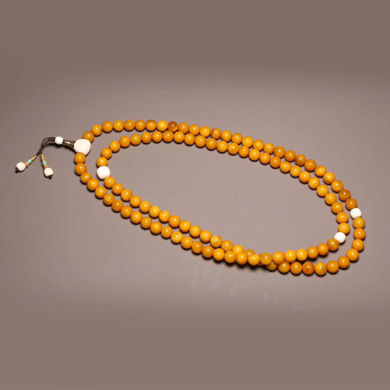 A STRAND OF BEESWAX PRAYER BEADS (1 of 8)