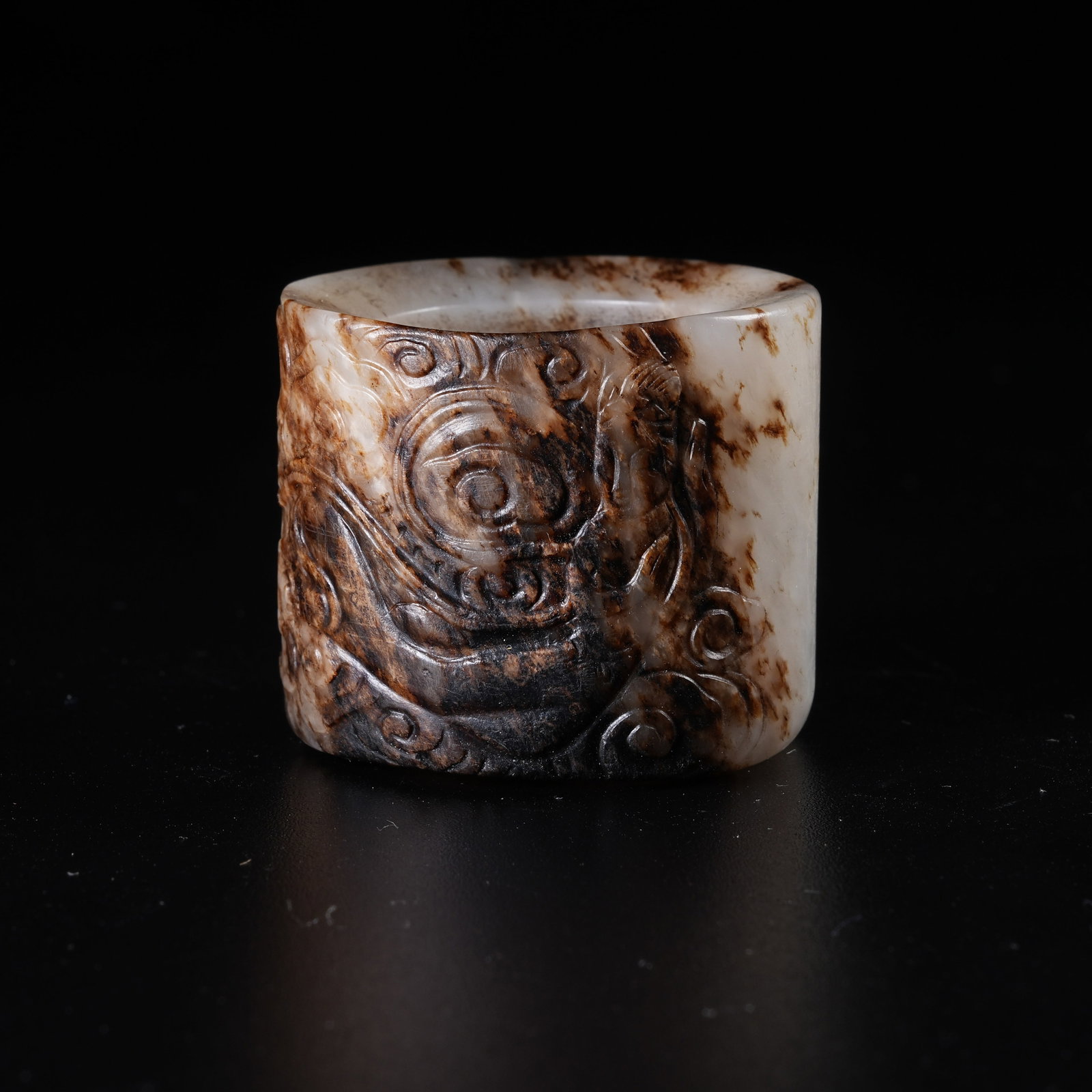 A ANCIENT JADE THUMB RING CARVED WITH FLYING APSARAS: Ancient Jade Thumb Ring Carved with Flying Apsaras
