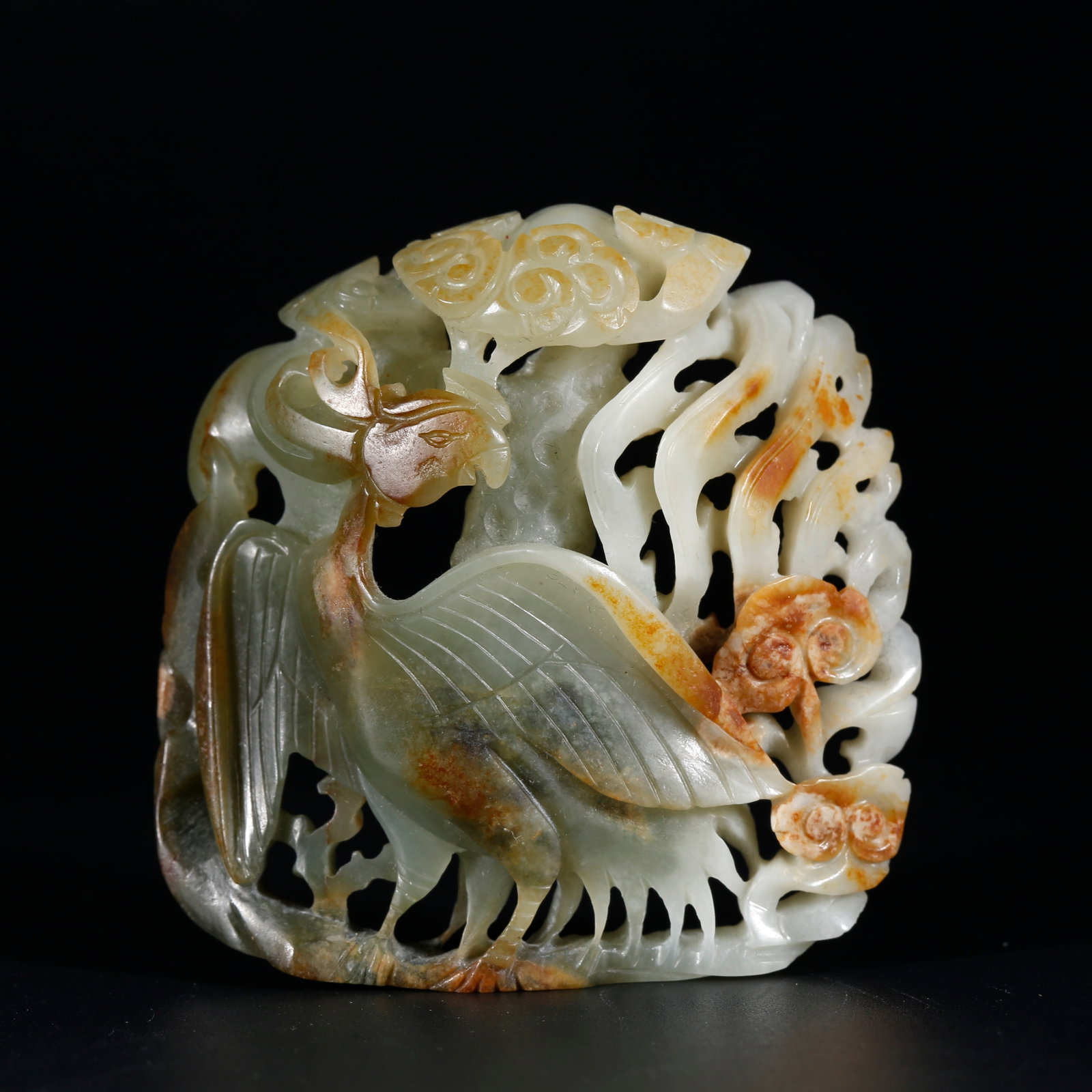 A HETIAN JADE PENDANT CARVED WITH BEAST MOTIFS: Hetian Jade Pendant Carved with Beast Motifs