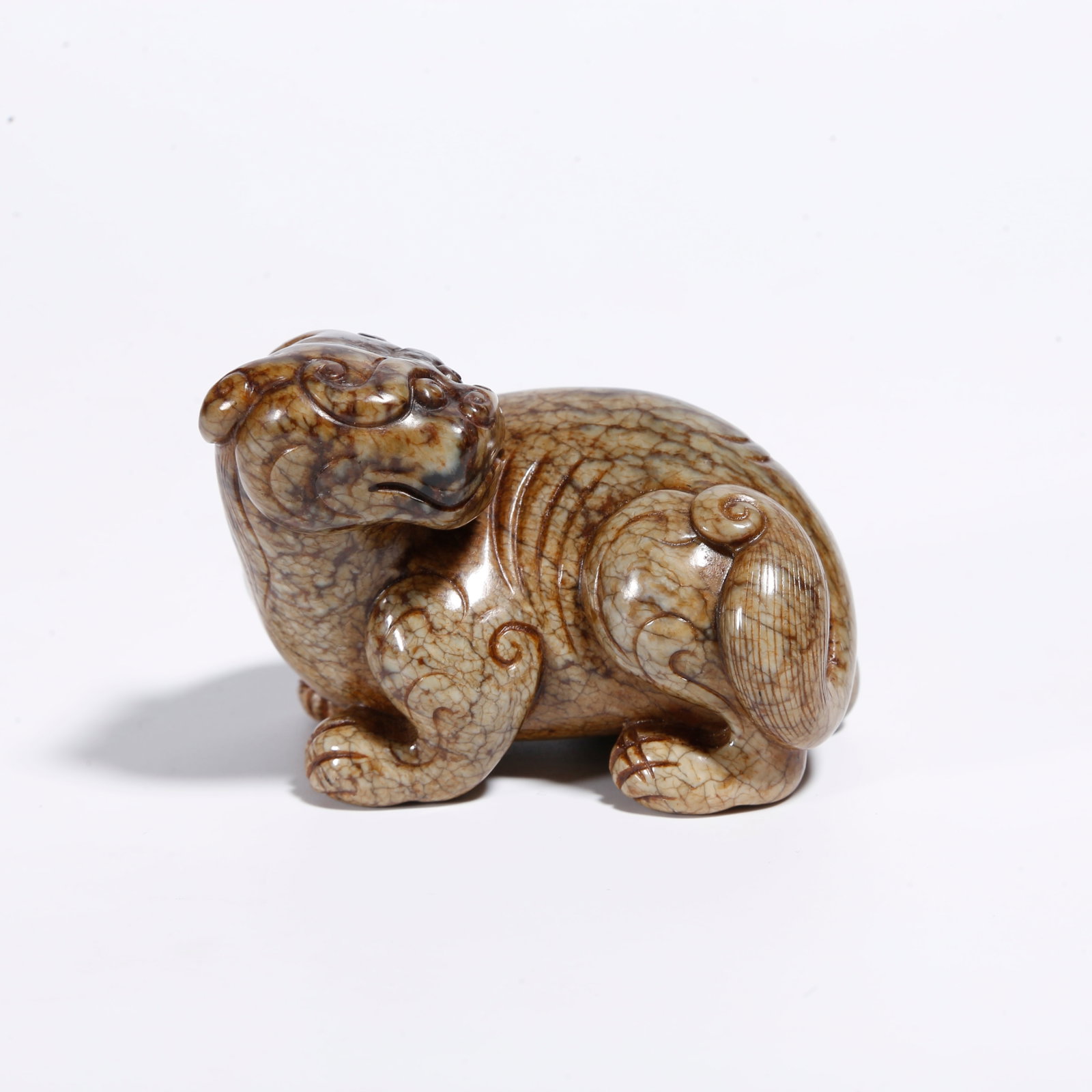 A HETIAN JADE AUSPICIOUS BEAST ORNAMENT: Hetian Jade Auspicious Beast Ornament