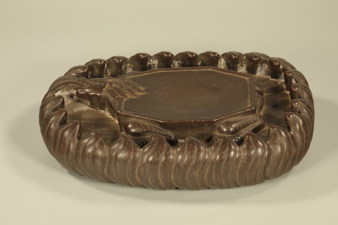 A DUAN INKSTONE WITH DRAGON AMID WAVES CARVING: Duan Inkstone with Dragon amid Waves Carving