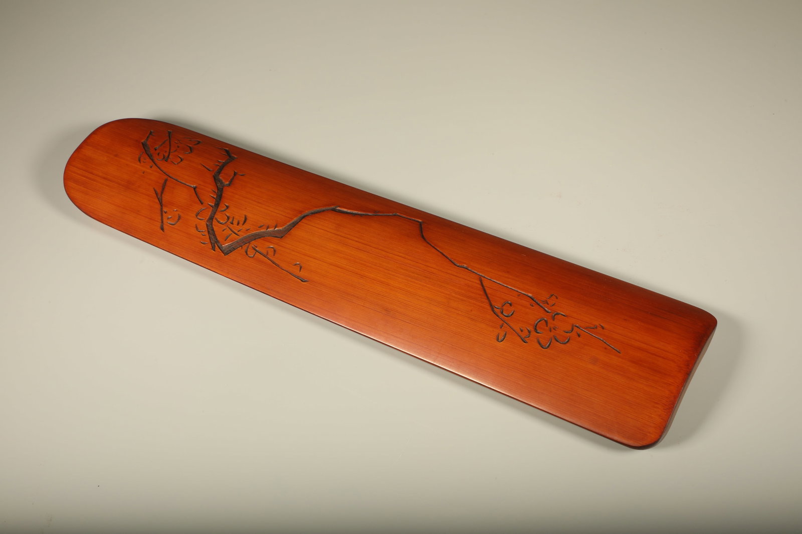 A BAMBOO CARVED WRIST REST WITH PLUM BLOSSOMS AND FIGURES (1 of 6)