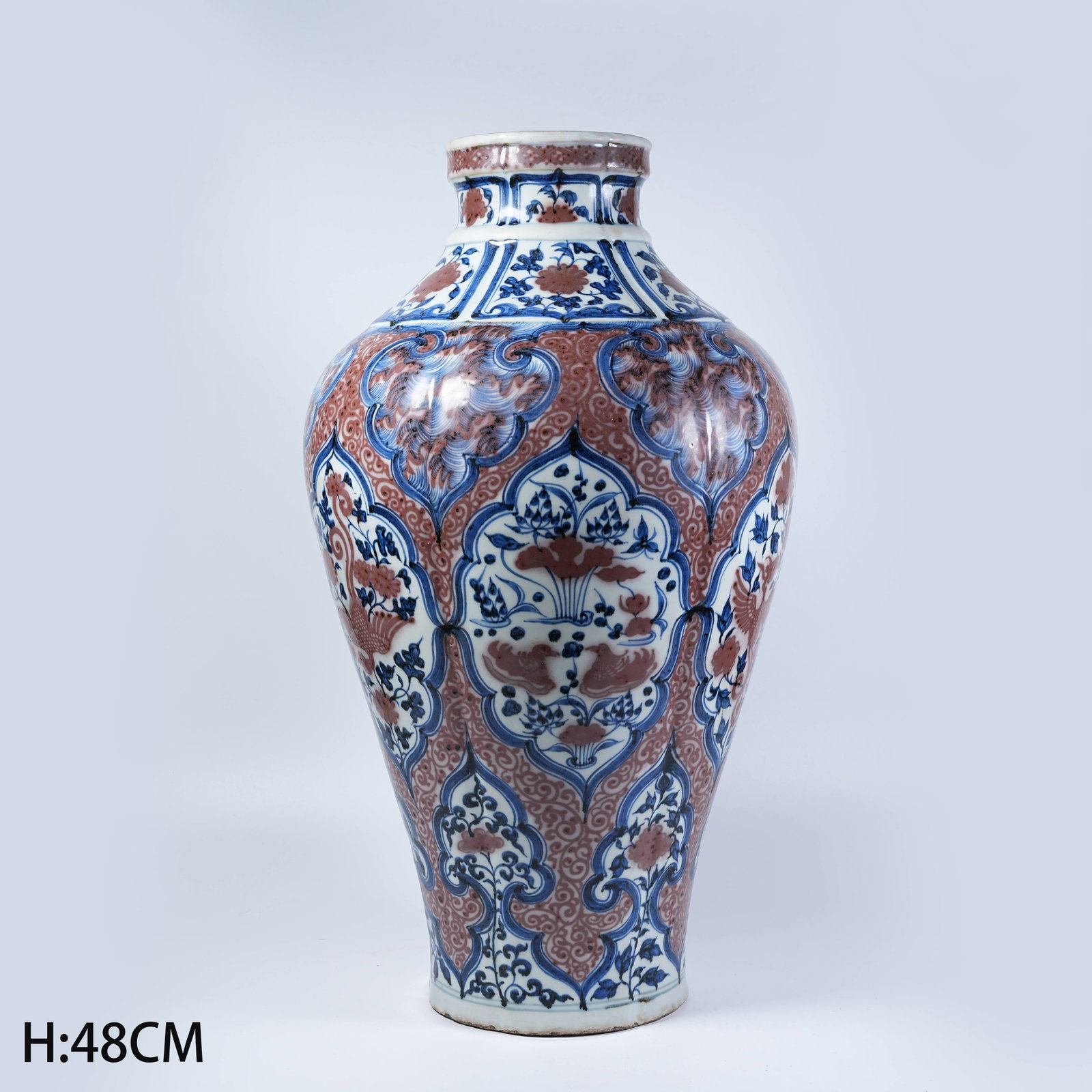 A PLUM VASE WITH BLUE AND WHITE UNDERGLAZE RED FLORAL PATTERNS: Plum Vase with Blue and White Underglaze Red Floral Patterns