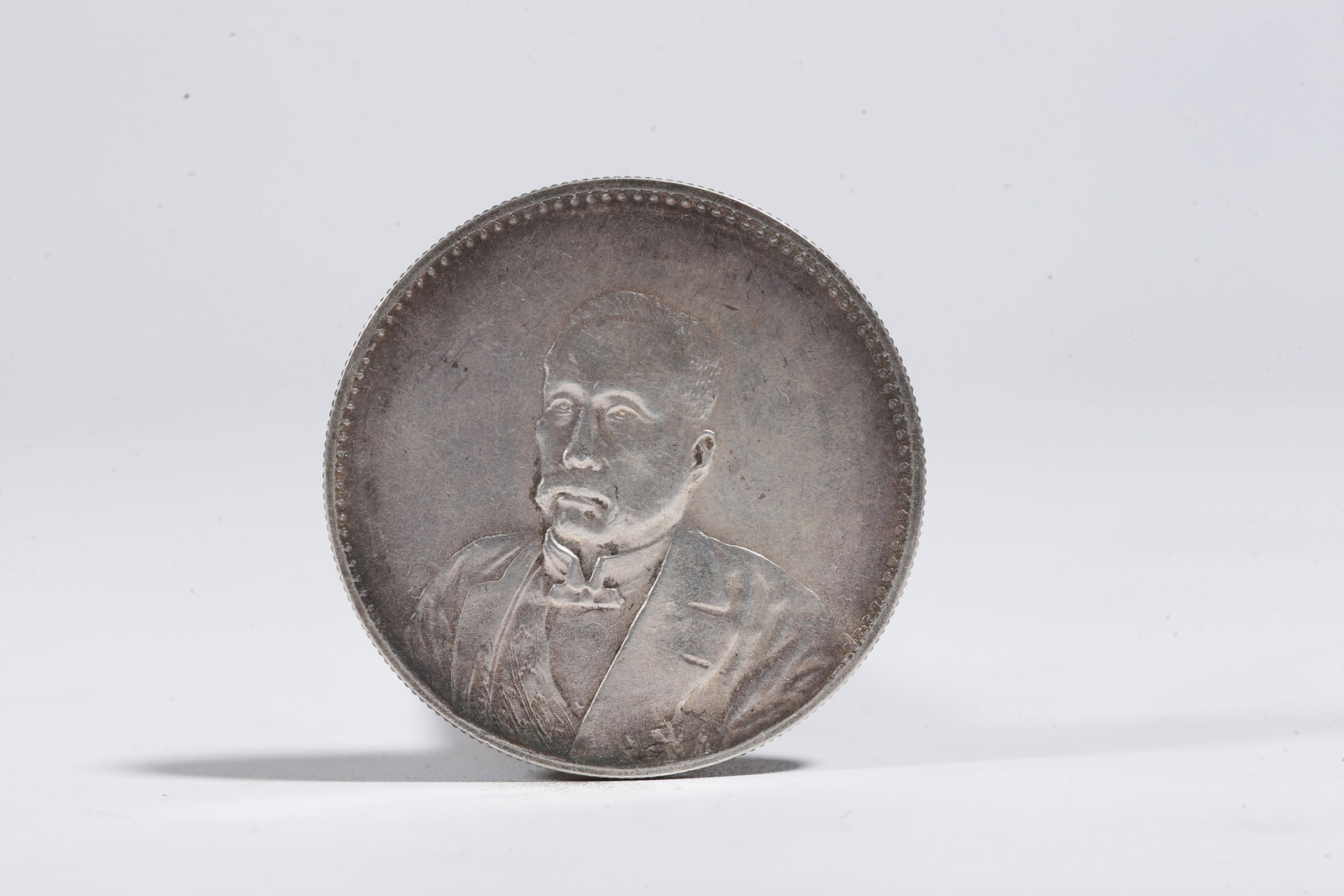 A SILVER DOLLAR COIN - 3