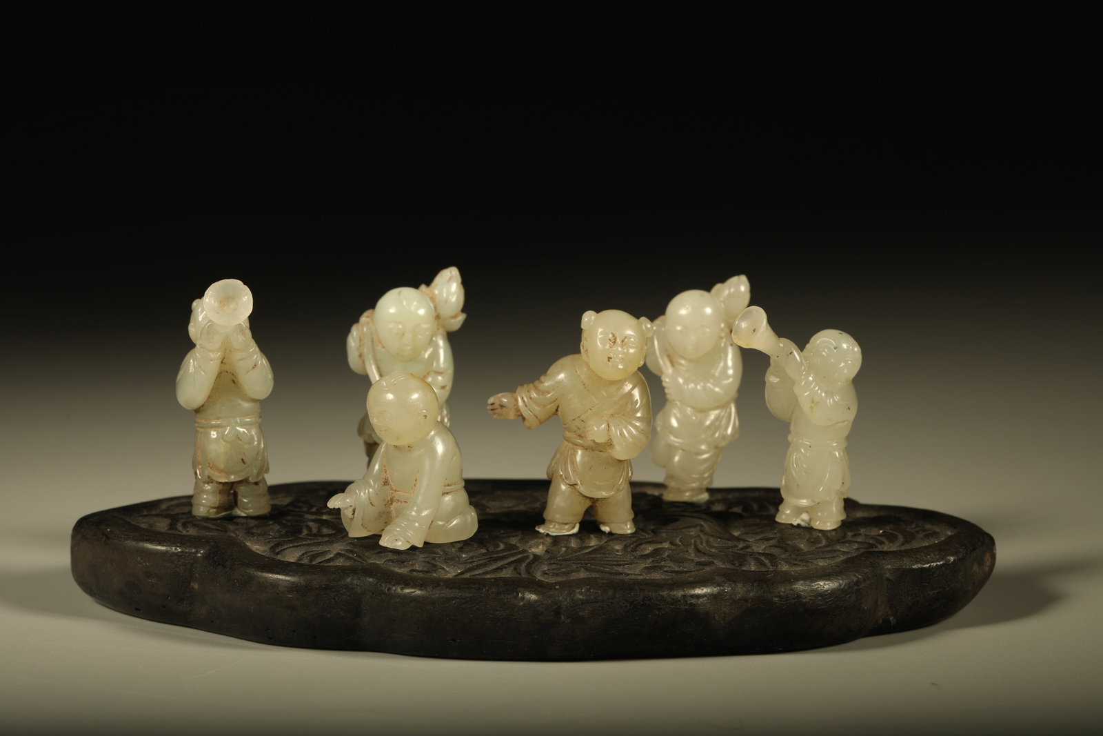 A SET OF SIX HETIAN JADE ORNAMENTS OF VARIOUS BOYS (1 of 9)