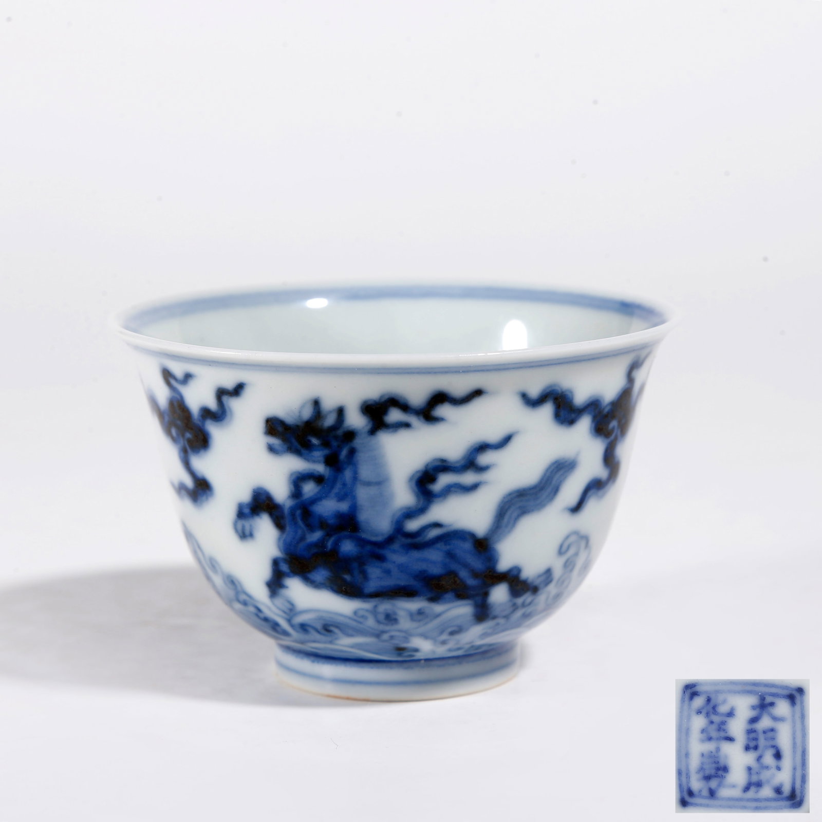 A BLUE AND WHITE CUP WITH BEAST PATTERN: Blue and White Cup with Beast Pattern