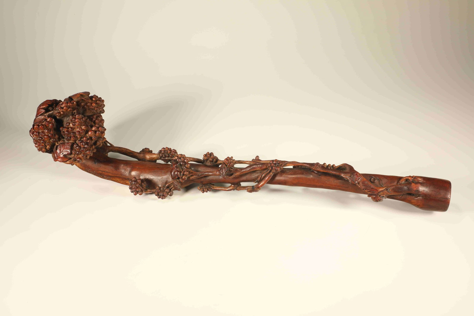 A HUANGHUALI BURL WOOD INGENIOUSLY CARVED RUYI WITH SQUIRRELS AND GRAPES: Huanghuali Burl Wood Ingeniously Carved Ruyi with Squirrels and Grapes