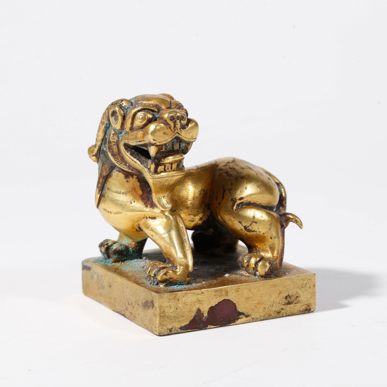 A GILT BRONZE SEAL WITH BEAST KNOB: Gilt Bronze Seal with Beast Knob