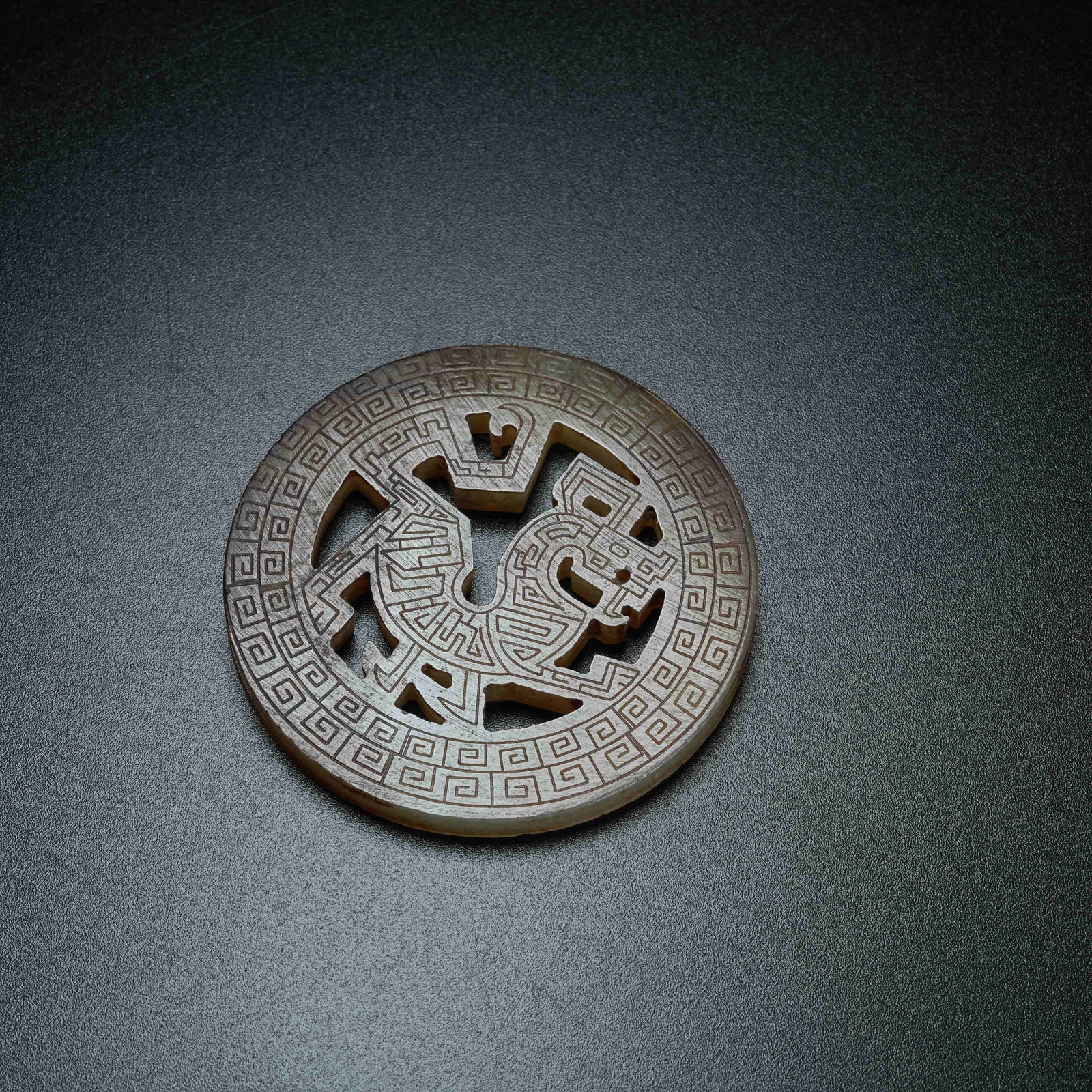 A ANCIENT JADE BI DISC CARVED WITH CHI DRAGON PATTERNS: Ancient Jade Bi Disc Carved with Chi Dragon Patterns