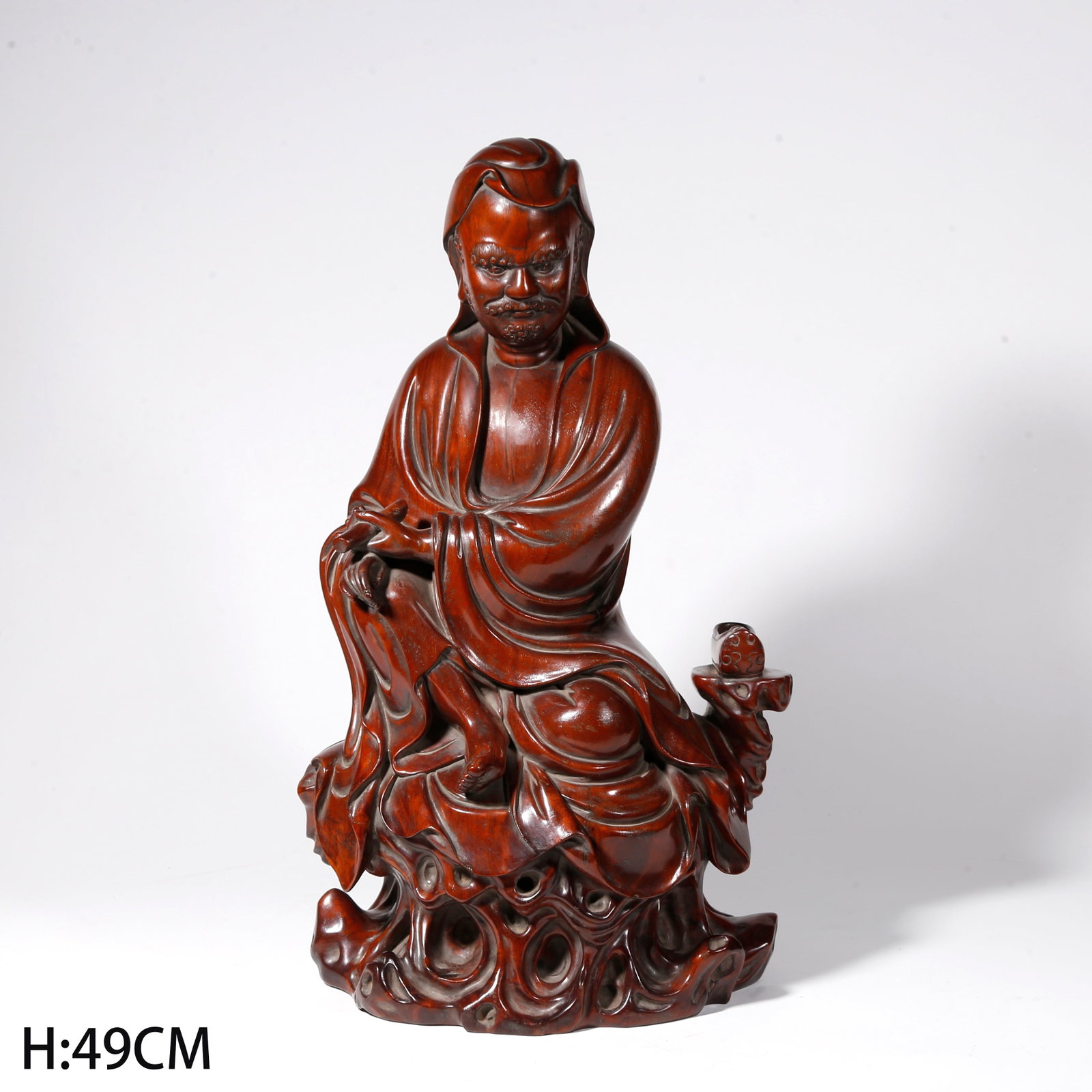 A HUANGHUALI WOOD CARVED DHARMA STATUE HOLDING SUTRA: Huanghuali Wood Carved Dharma Statue Holding Sutra