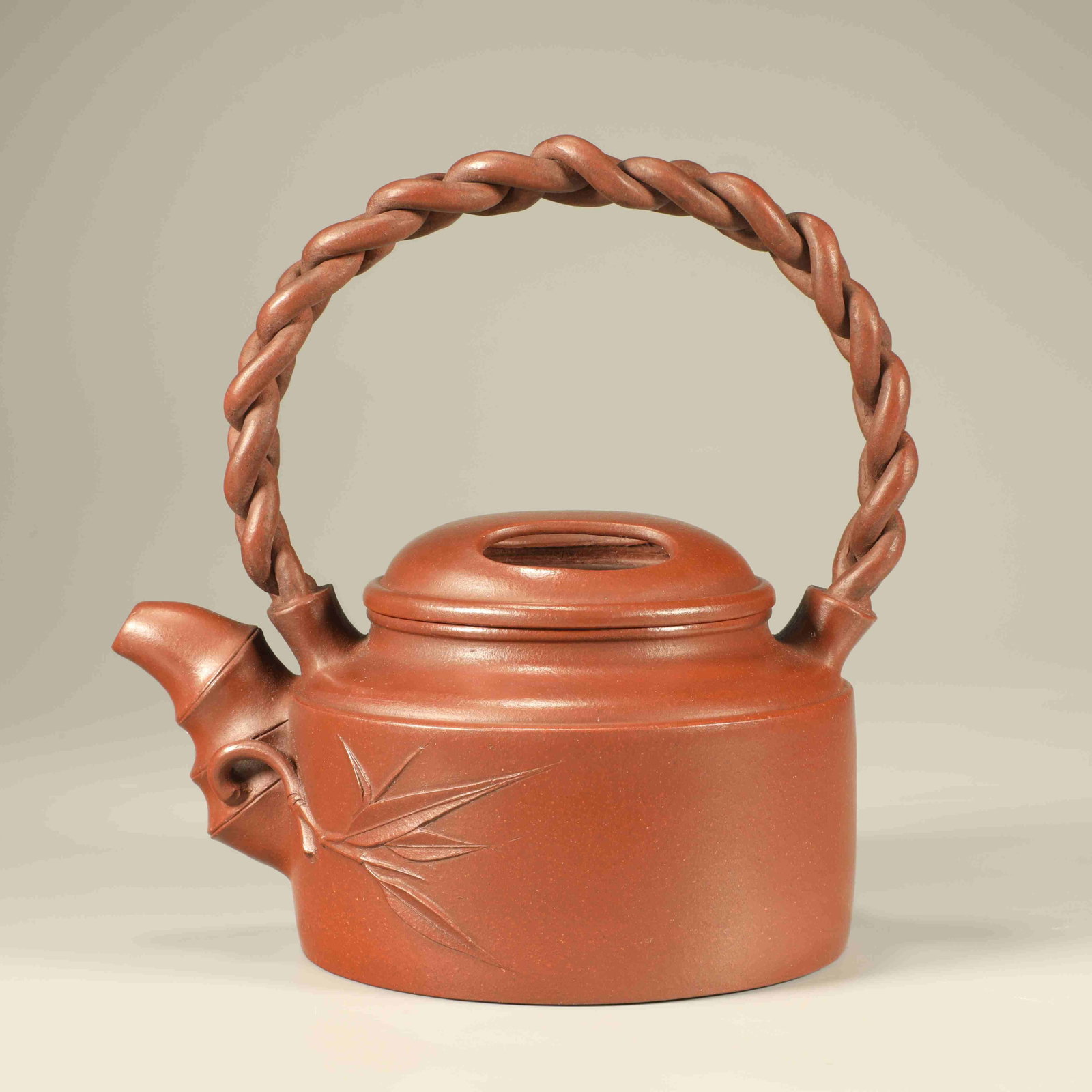 A YIXING CLAY TEAPOT WITH COW LID AND TWISTED HANDLE: Yixing Clay Teapot with Cow Lid and Twisted Handle