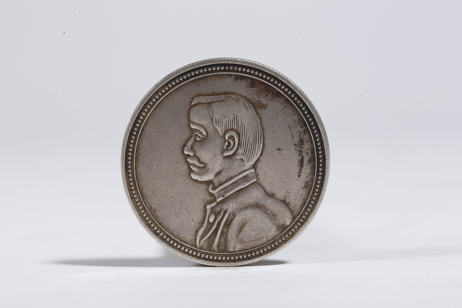 A SILVER DOLLAR COIN - 3