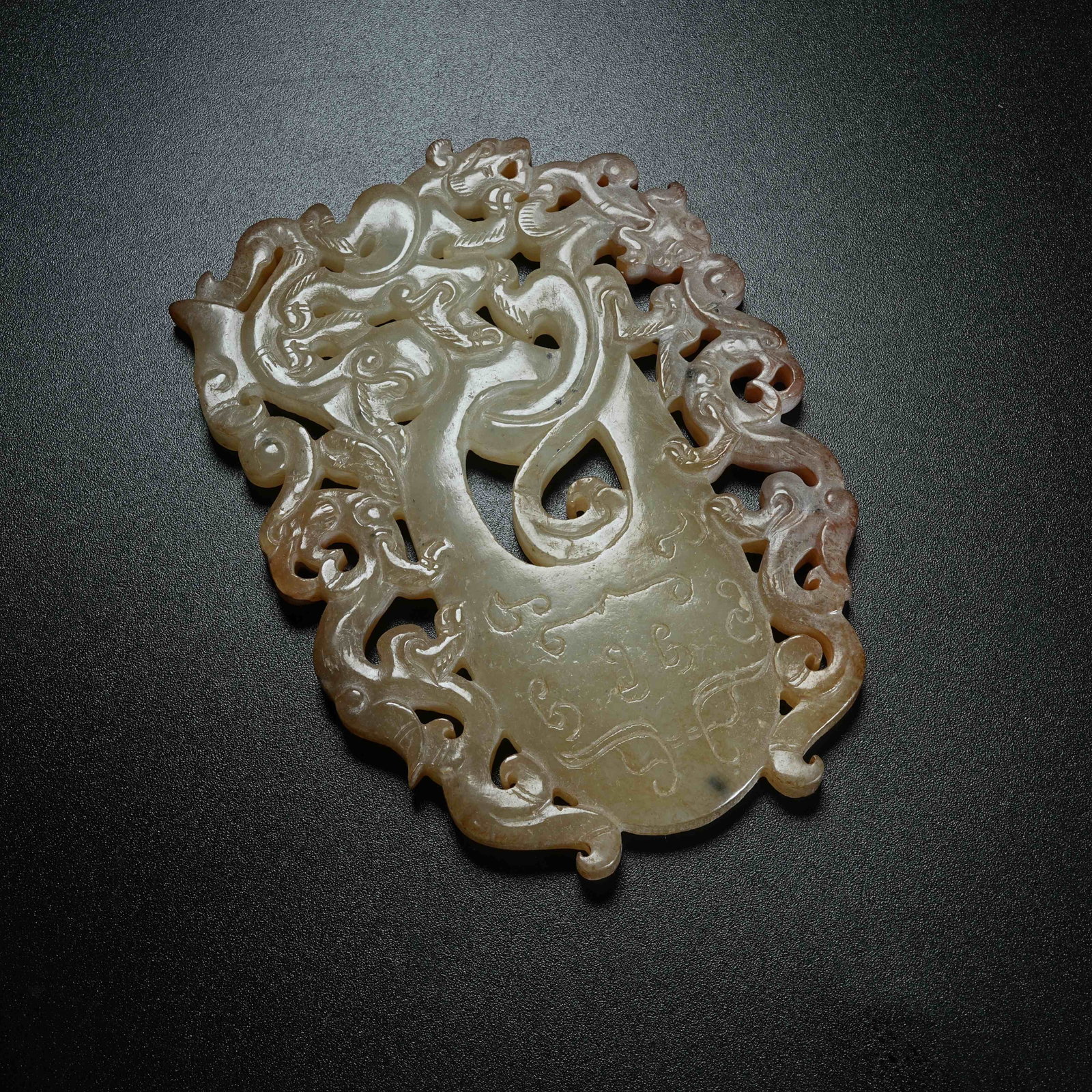 A ARCHAIC JADE HEART-SHAPED PENDANT CARVED WITH CHILONG PATTERNS: Archaic Jade Heart-shaped Pendant Carved with Chilong Patterns