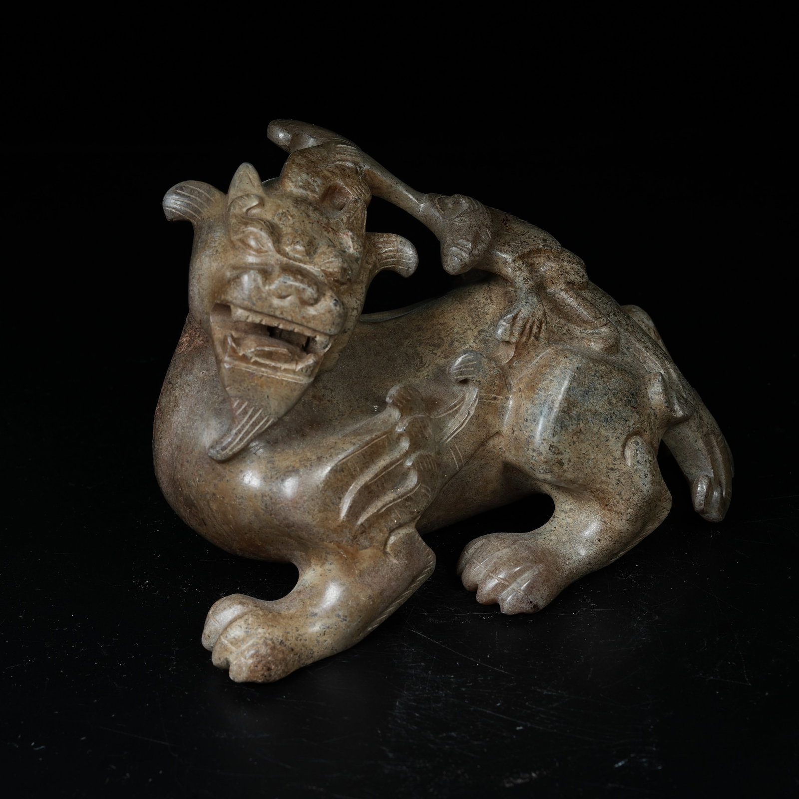 A ARCHAIC JADE ORNAMENT OF WINGED IMMORTAL RIDING BEAST: Archaic Jade Ornament of Winged Immortal Riding Beast