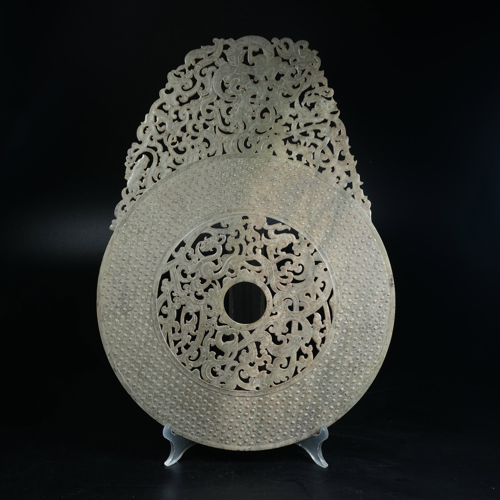 A ANCIENT JADE OPENWORK BI DISC CARVED WITH CHI DRAGON PATTERNS EXTENDING BEYOND RIM: Ancient Jade Openwork Bi Disc Carved with Chi Dragon Patterns Extending Beyond Rim