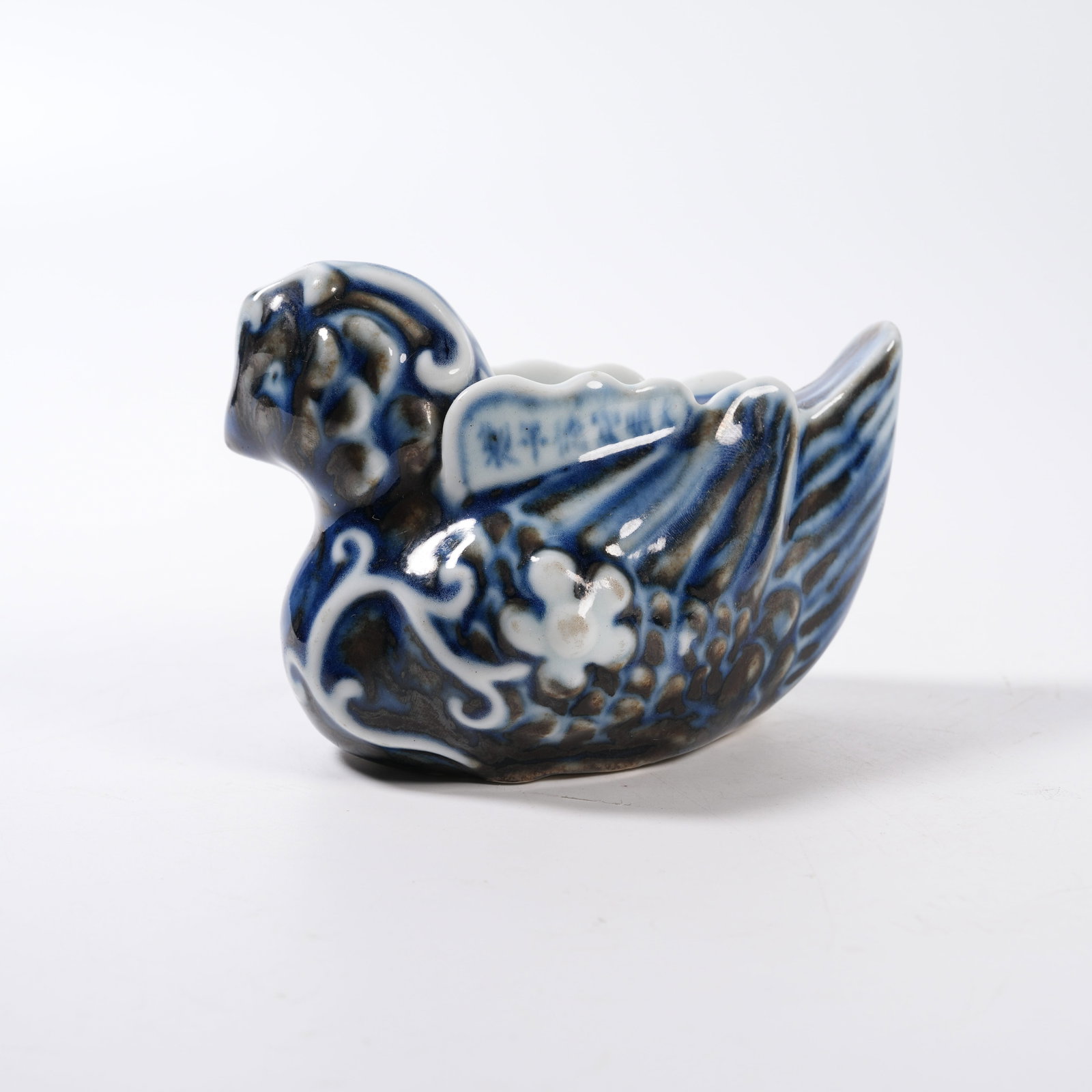 A BLUE AND WHITE MANDARIN DUCK SHAPED INK DROPPER: Blue and White Mandarin Duck Shaped Ink Dropper