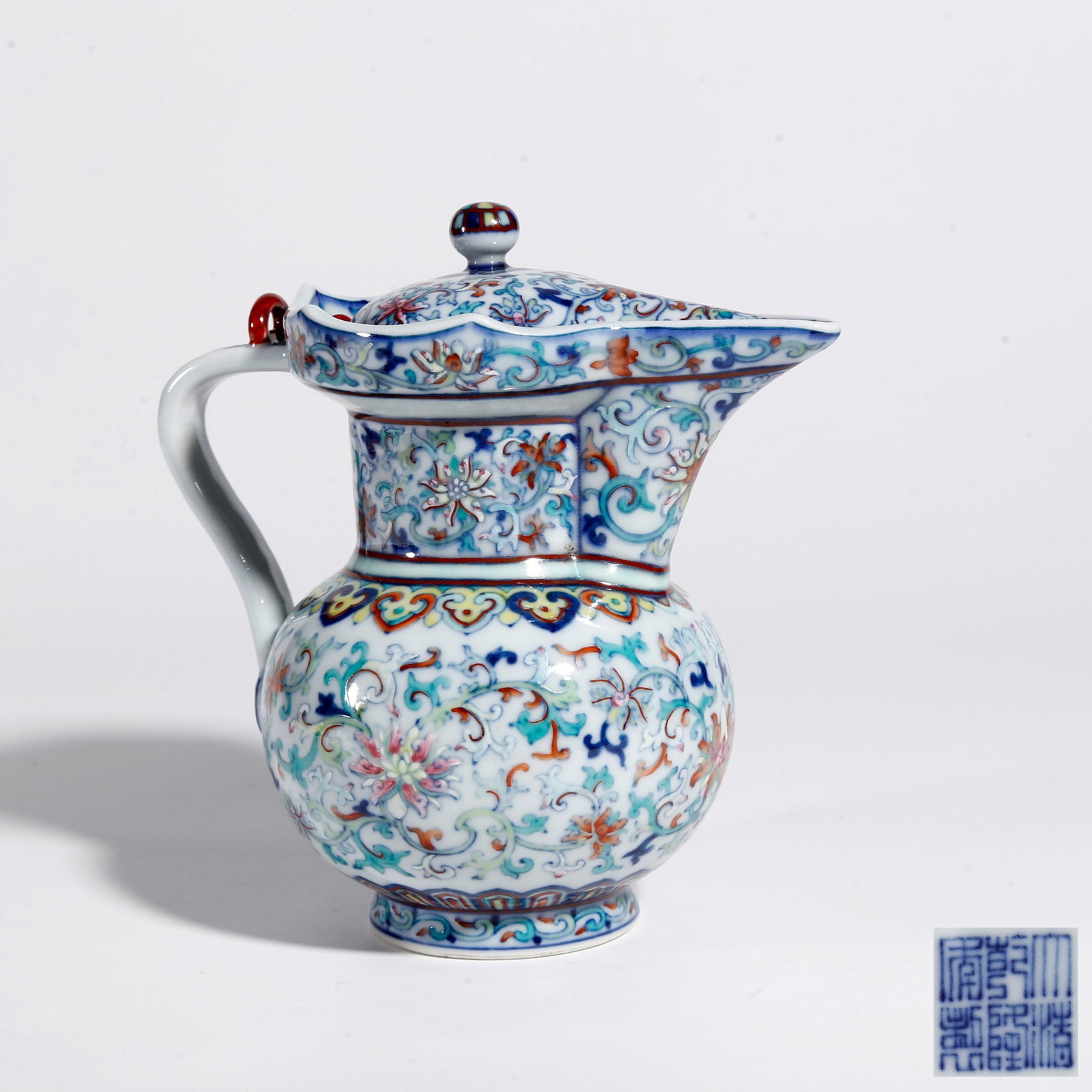 A DOUCAI MONK'S CAP EWER WITH INTERLOCKING FLORAL SCROLL PATTERN: Doucai Monk's Cap Ewer with Interlocking Floral Scroll Pattern